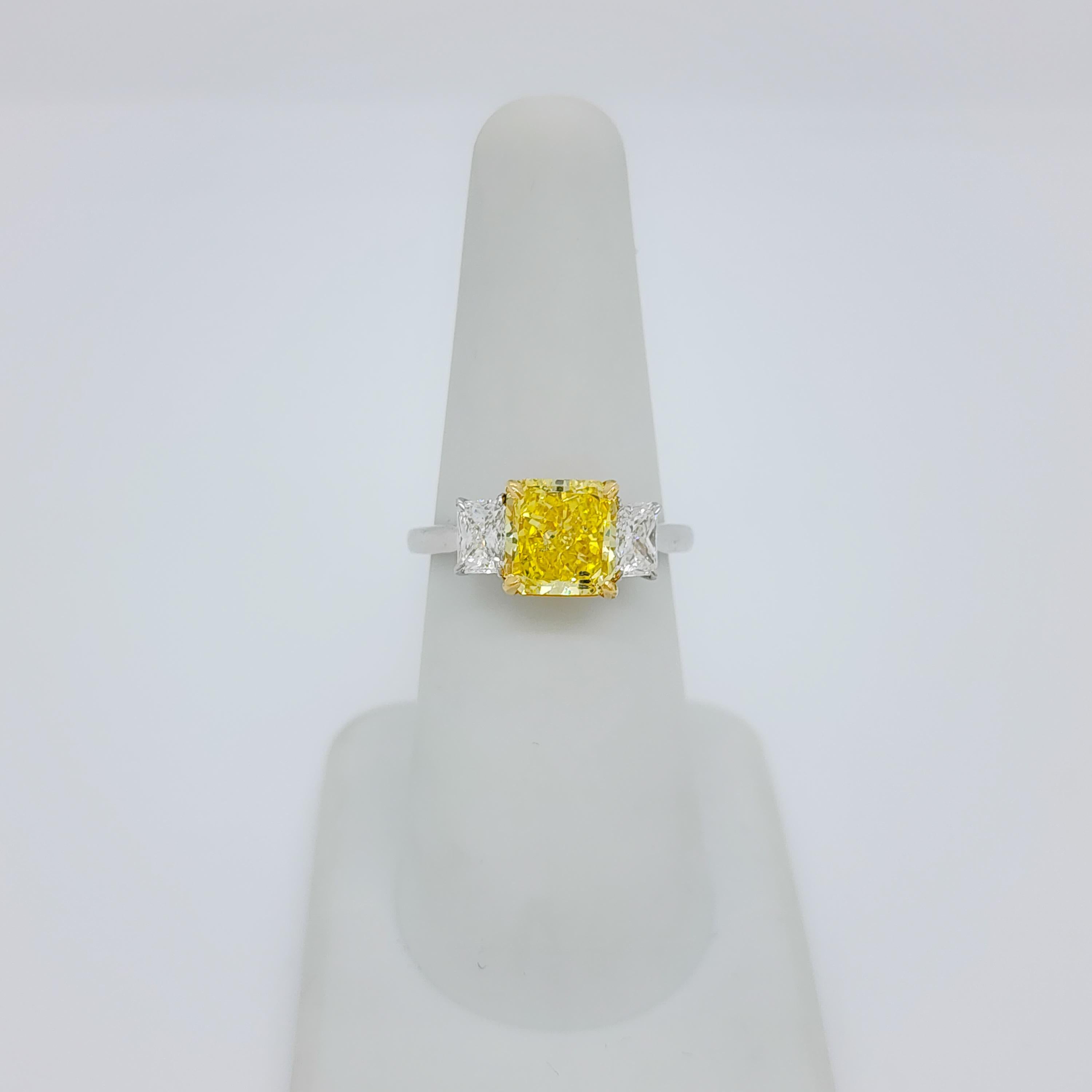 GIA Fancy Vivid Yellow Radiant and White Diamond Three Stone Ring in 18k  In New Condition In Los Angeles, CA
