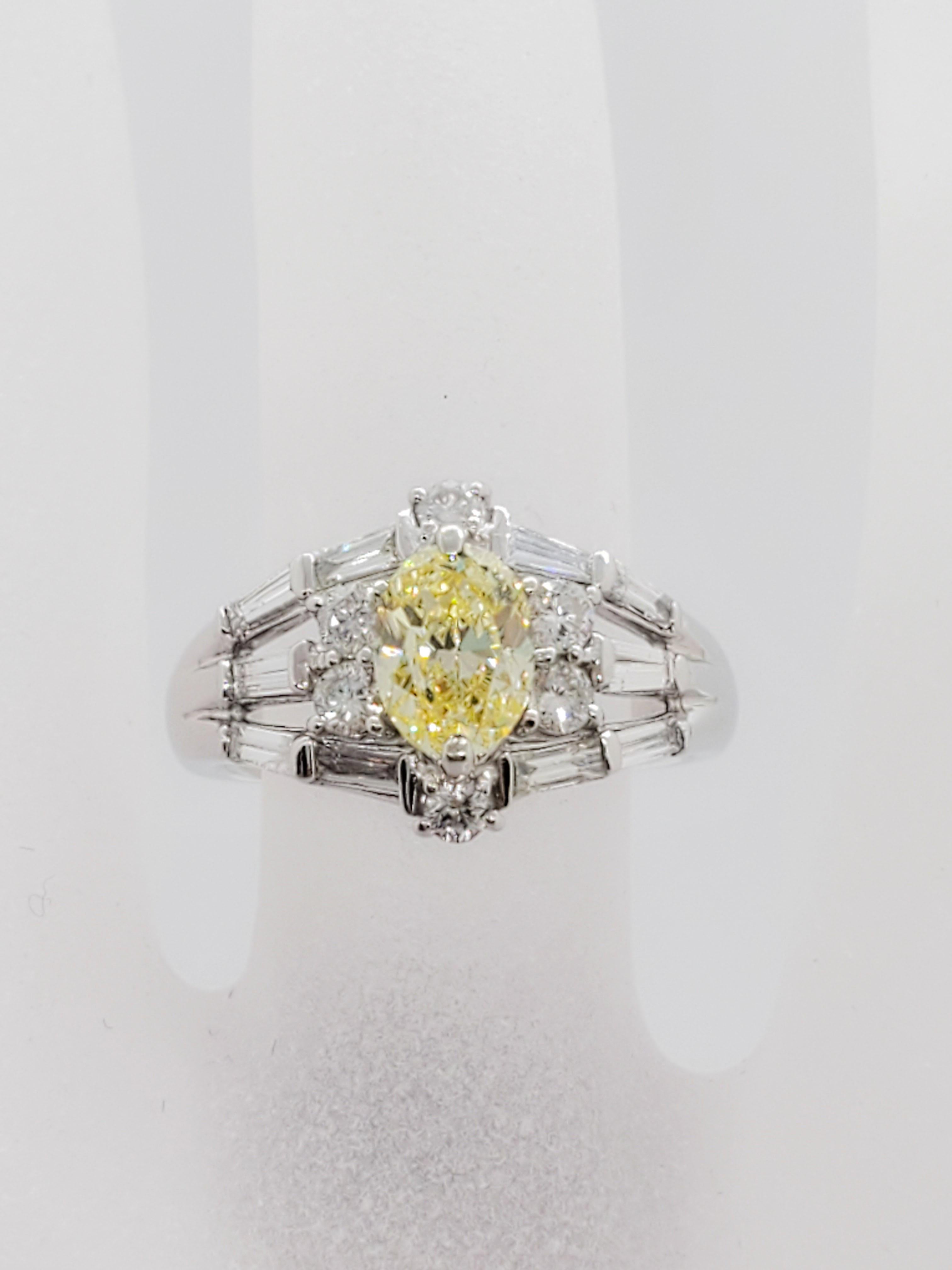 Gorgeous 1.01 ct fancy yellow diamond oval, SI2 clarity.  0.84 ct of white diamond baguettes and rounds in a beautiful handmade platinum mounting.  GIA certified and size 6.  A great ring for engagement or right hand.  