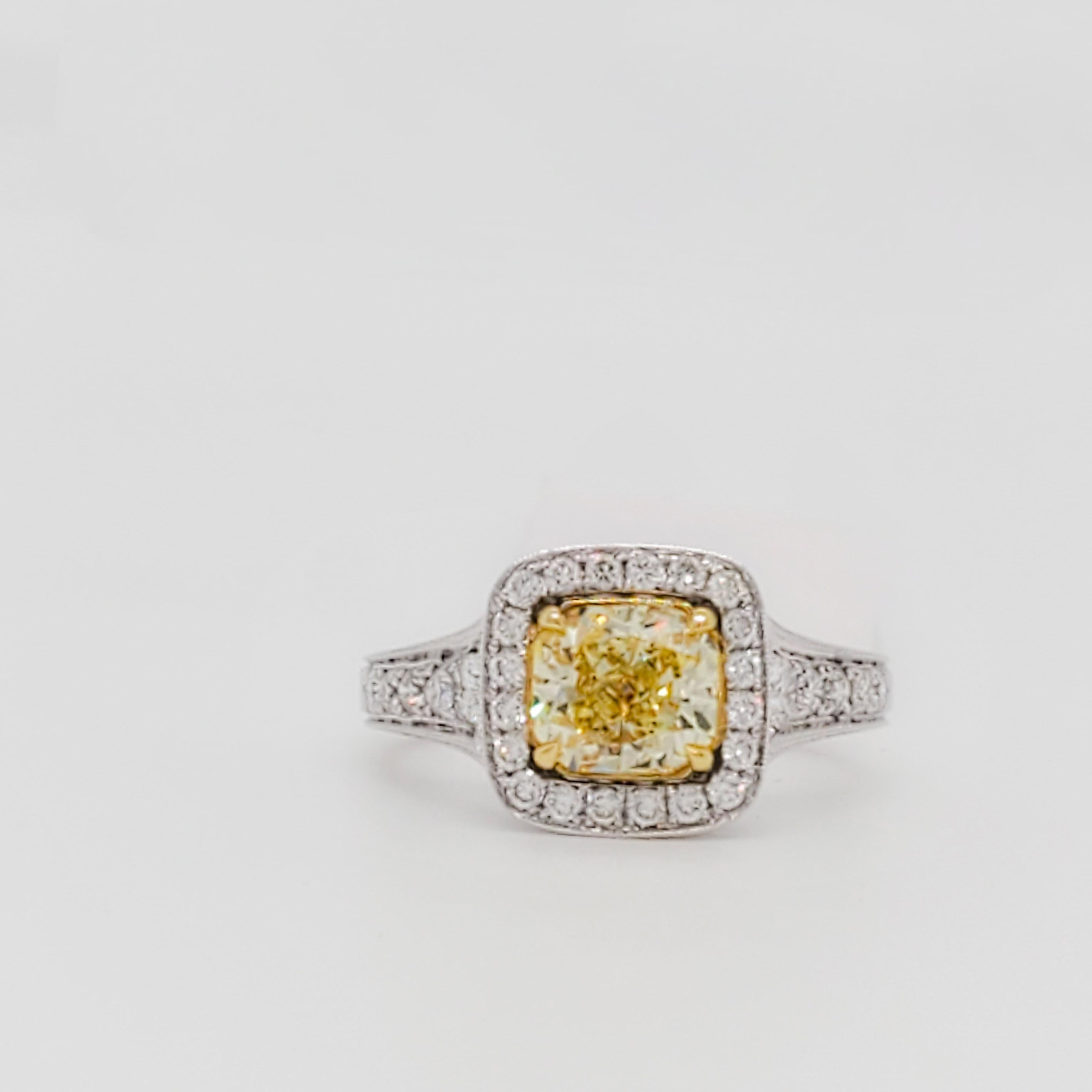 Beautiful 1.44 ct. GIA fancy yellow diamond radiant with 0.45 ct. good quality white diamond rounds.  Handmade in 18k yellow and white gold.  Ring size 