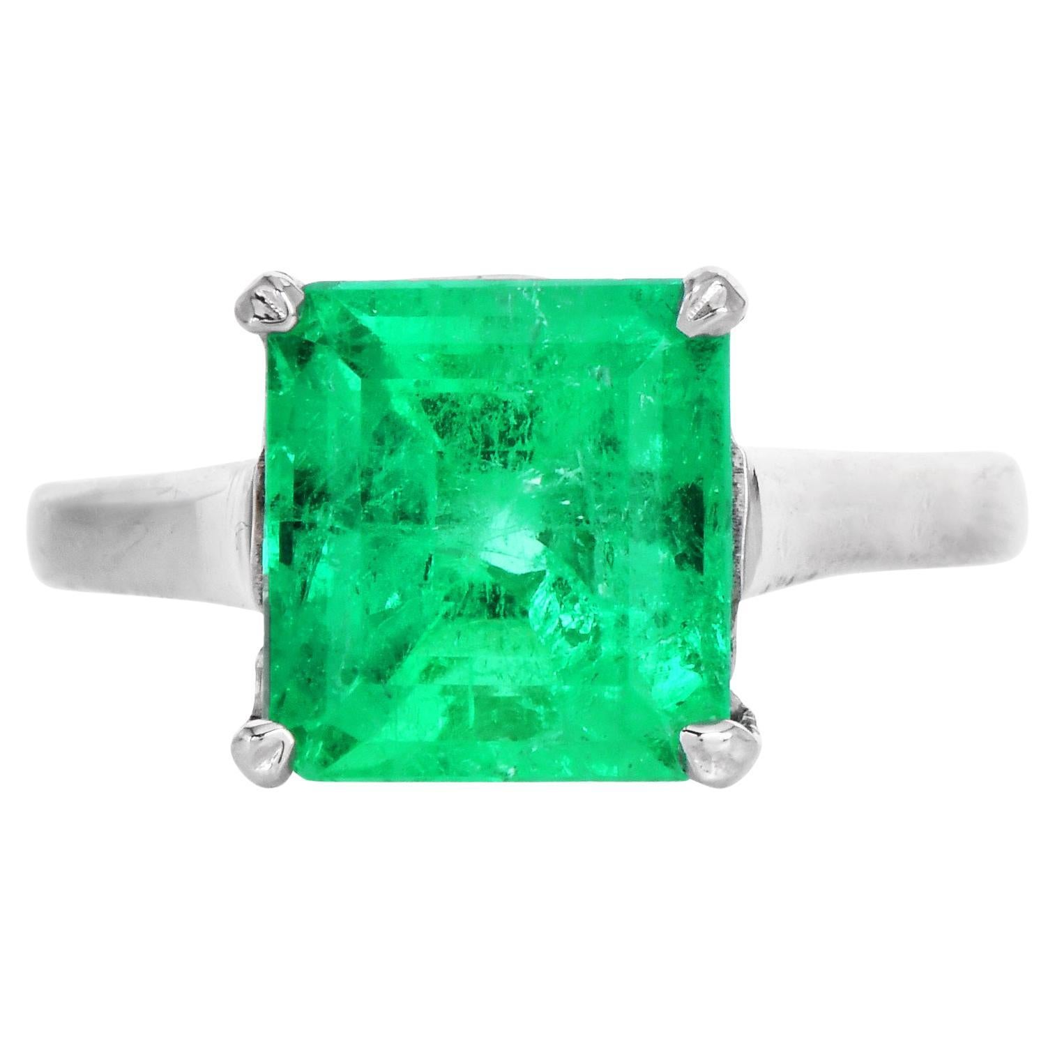 This classic Emerald Solitaire ring is crafted in solid 14k gold. It is exposed at the center with fine Assher-cut genuine Colombian Emerald, GIA certified, weighing 4.62 carats measuring approx: 10.04 x 9.30 x 7.54mm; set in a tiffant style four