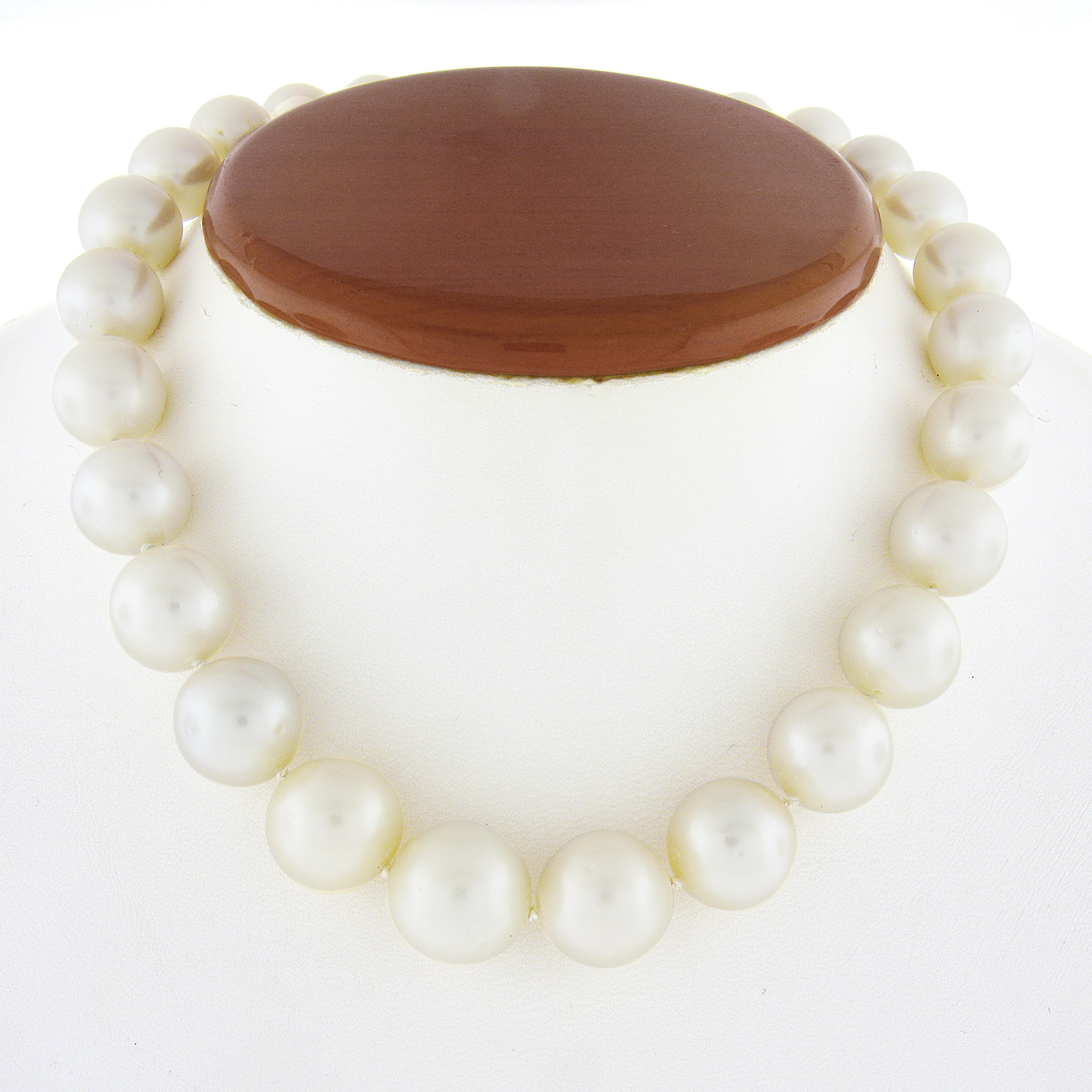 This stunning graduated pearl strand necklace features 26, GIA certified, white bead cultured south sea pearls that are near-round in shape. They perfectly graduate in size ranging from 10.8mm to 15.4mm and each of them has a very beautiful and