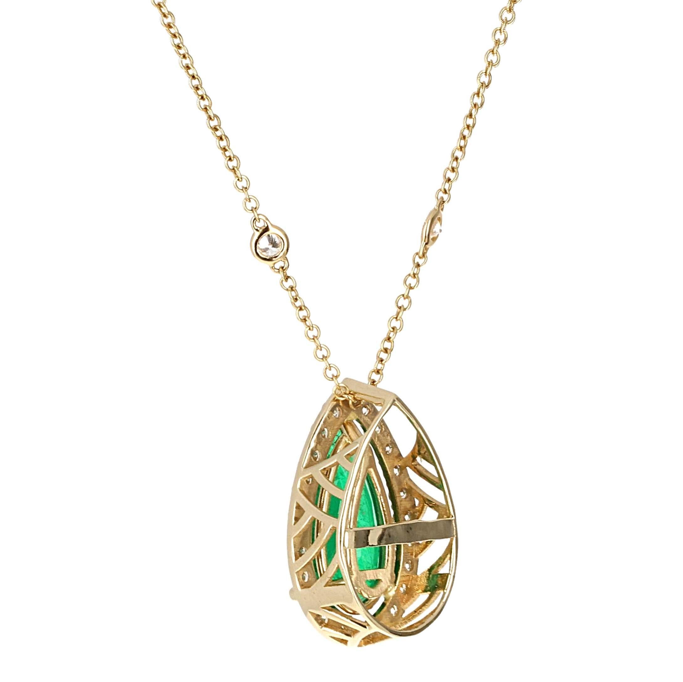 GIA Certified,  6.92 carat pear shape emerald and white diamond 14 karat yellow gold pendant. The pendant is crafted with meticulous attention to detail showcasing a geometric design on the side. This lively emerald is set in 14 karat yellow gold