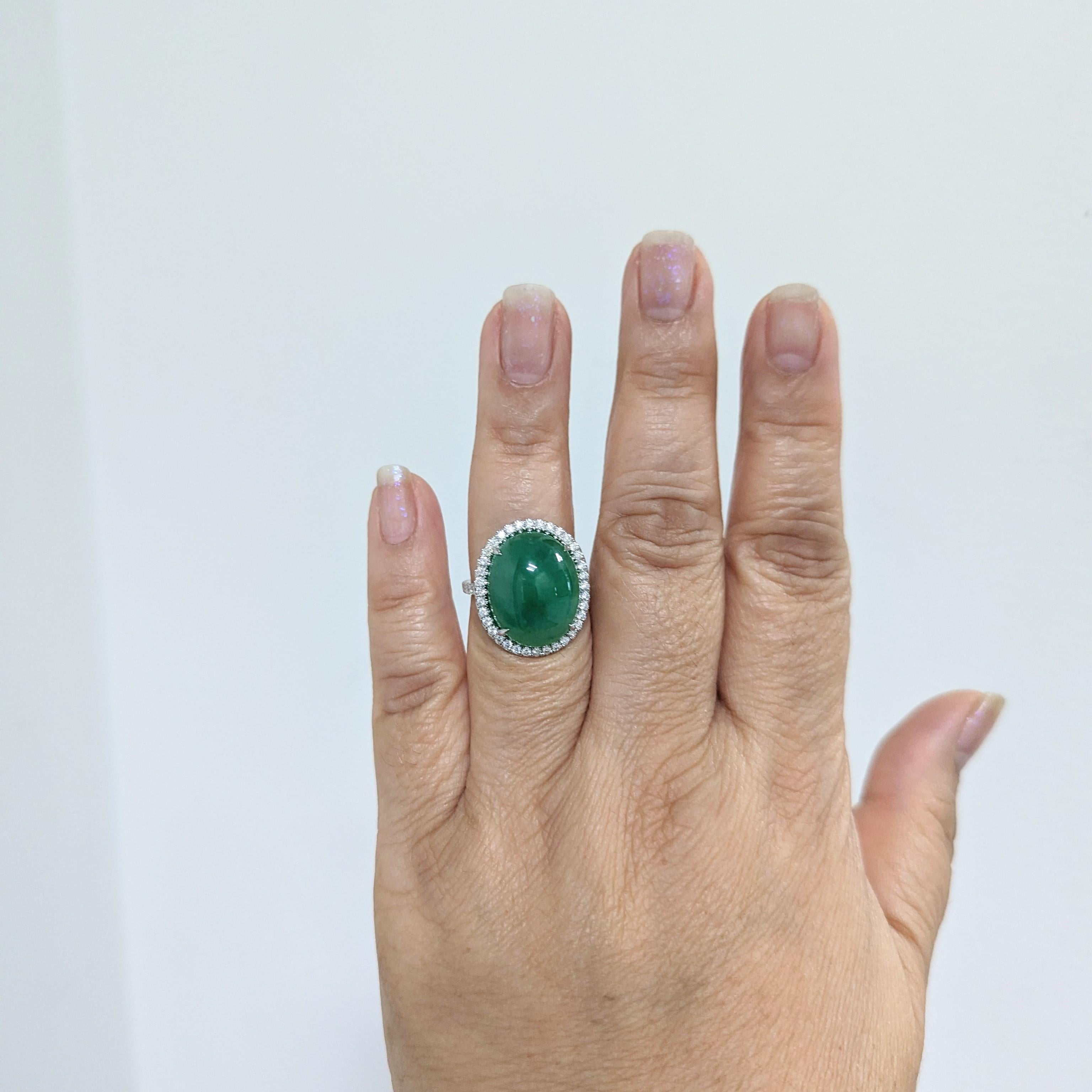 Beautiful 21.80 ct. GIA green jadeite oval cabochon with 0.75 ct. good quality white diamond rounds.  Handmade in platinum.  Ring size 7.25.