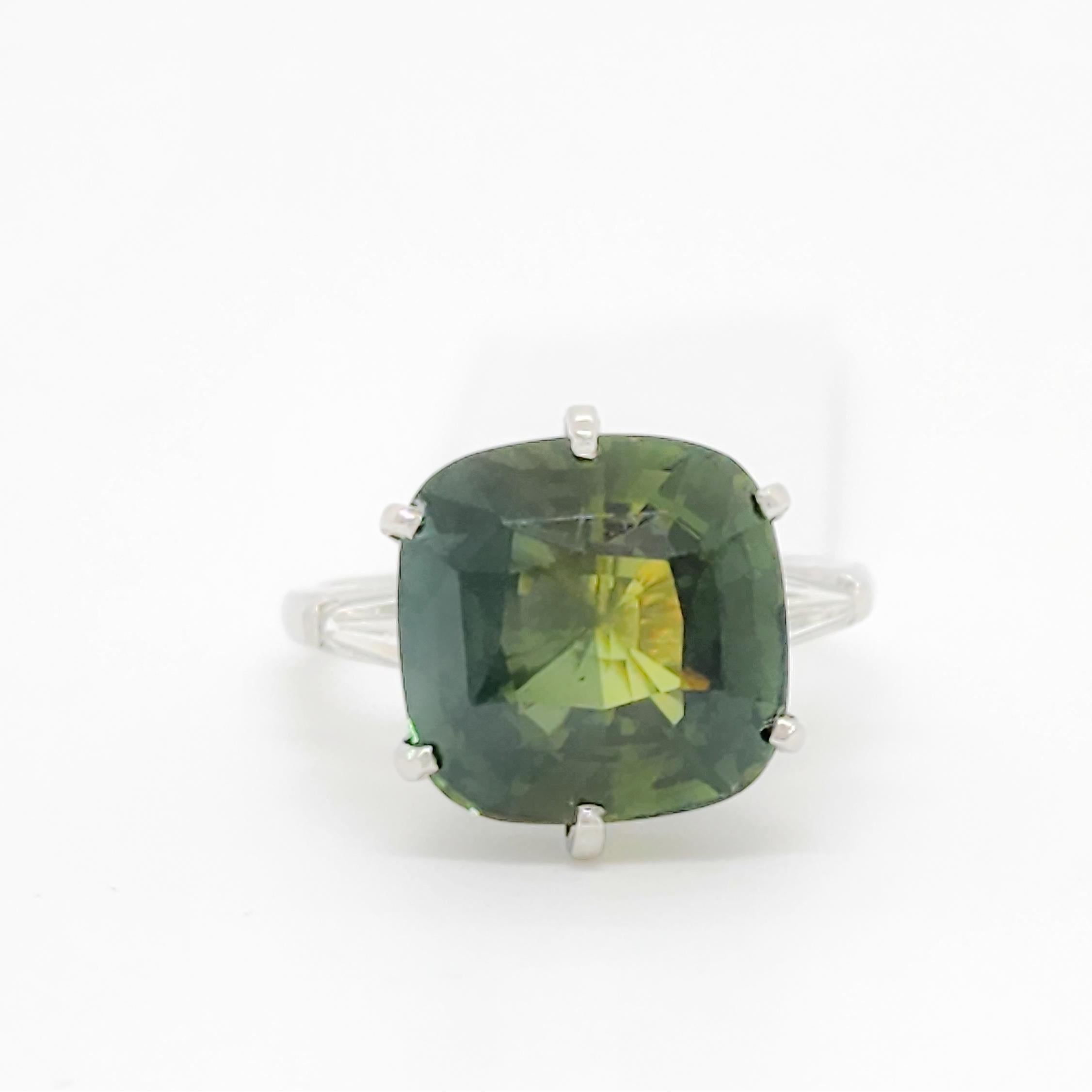 Gorgeous 9.97 ct. green sapphire cushion with 0.20 ct. good quality white diamond baguettes.  Handmade in platinum.  Ring size 6.75.  GIA certificate included.