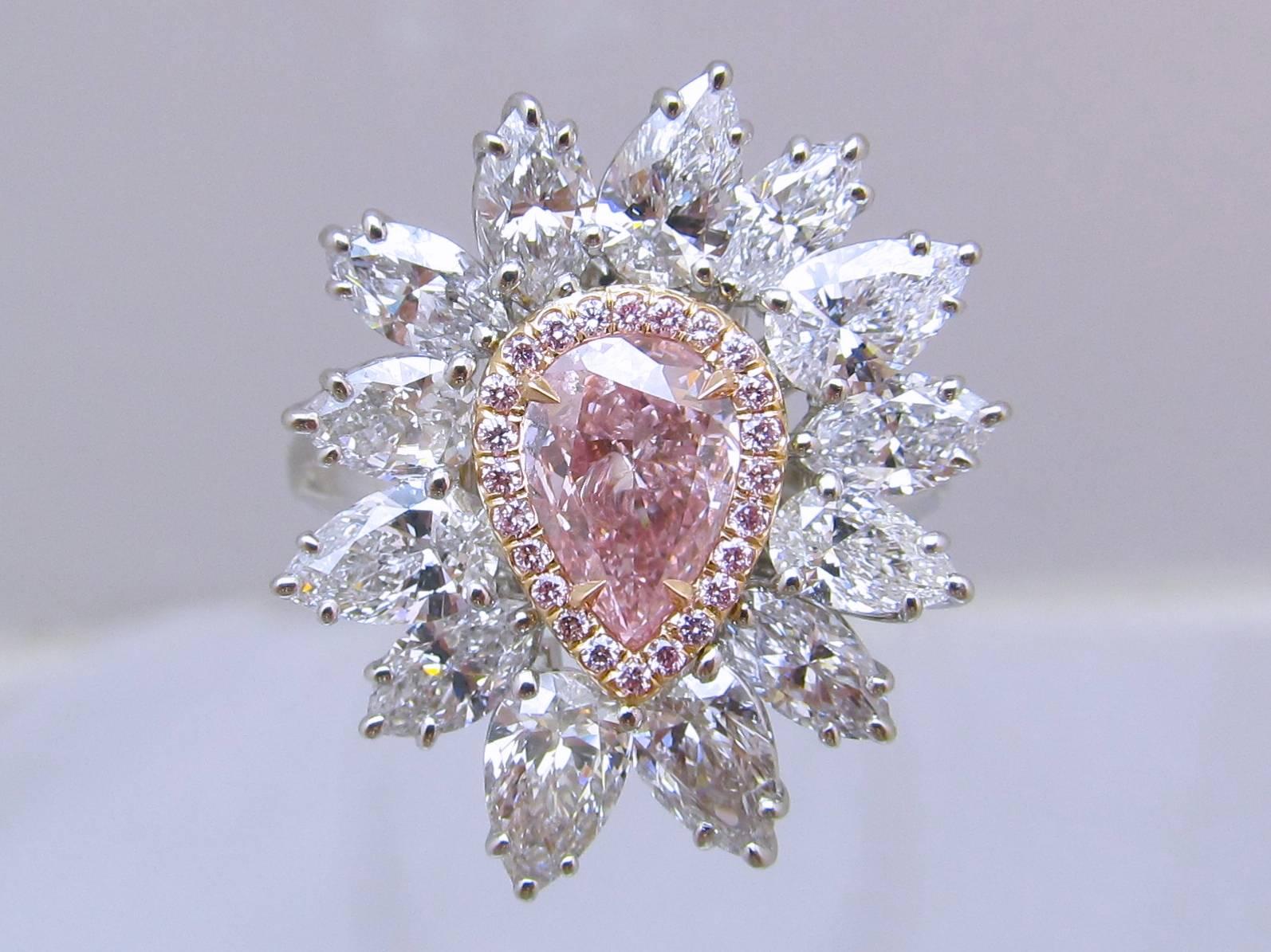 Nature's Wonder! Beautiful Intense Purplish Pink pear shape diamond is set in rose gold surrounded with 24 natural pink brilliant diamonds( total weight of 0.13 carats) then flared flower petals style with 13 top color pear shape diamonds ( total