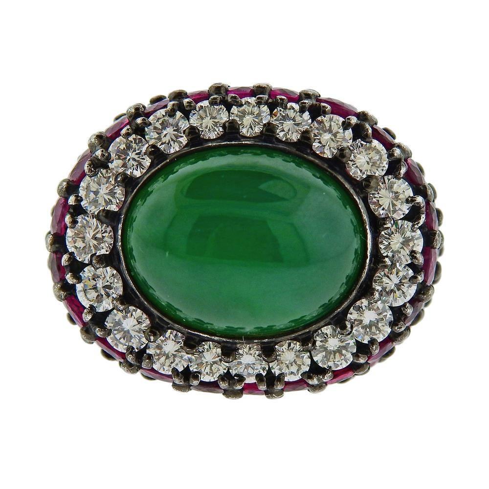 18k white gold cocktail ring. Set with vibrant rubies, GIA certified natural color 19.90 grams Jadeite jade - (14.70 x 11.80 x 7.52mm), and diamonds approx. 1.80ctw. Measures - 3 3/4, ring top is 19.5mm wide. Marked 18k 750. Weight 19.9 grams. Comes
