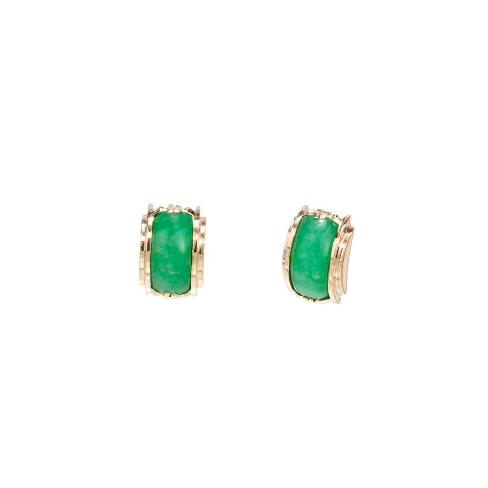 1940's Late Art Deco Jade stud earrings. GIA certified two oval arc shaped cabochon earrings mounted in 18k rose gold settings. GIA has certified these as natural, no indications of impregnation and Grade A jadeite,

2 oval green arc cabochon