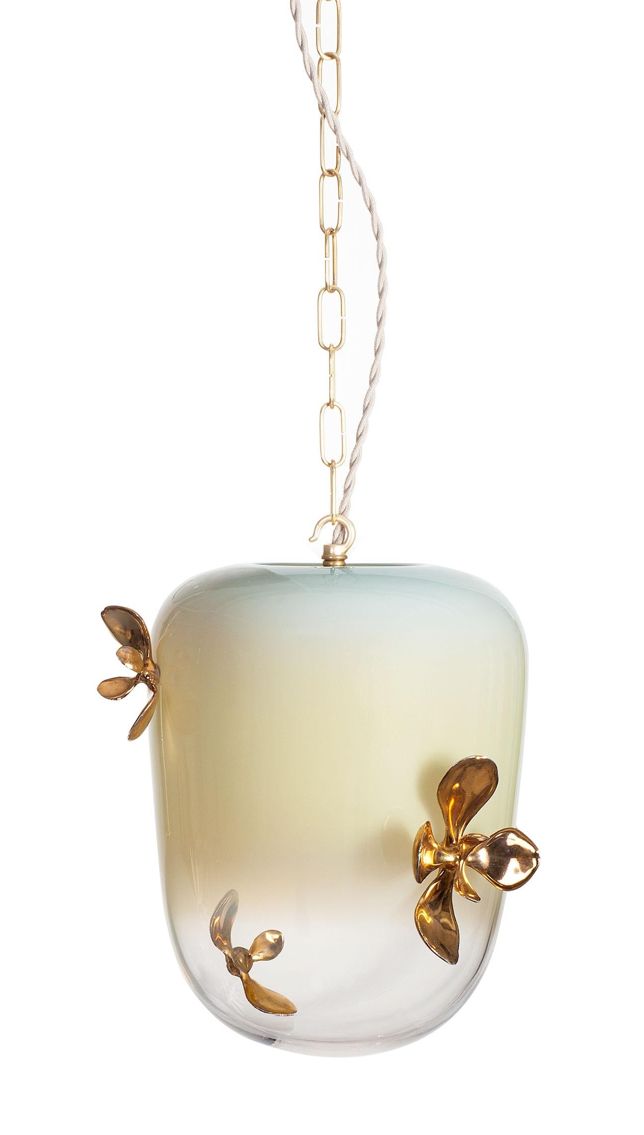 The Gia lighting collection consists of hand blown glass adorned with hand built porcelain plants. The glass pieces are offered in three forms: globe, lantern or bell.  The handcrafted porcelain ornaments are cast from live succulent plants. The