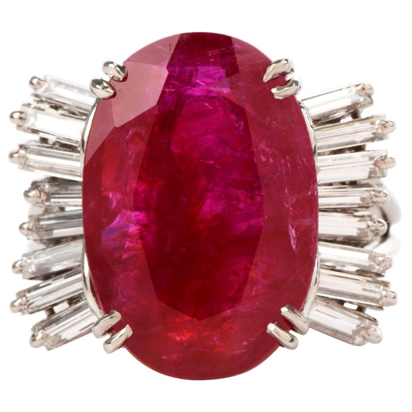 This chic ruby and diamond cocktail ring is crafted in solid platinum, weighing 9.2 grams and 17mm x 9mm high. Showcasing a prominent GIA lab reported oval shaped, prong-set red ruby with no indications of heating, weighing approximately, 9.10