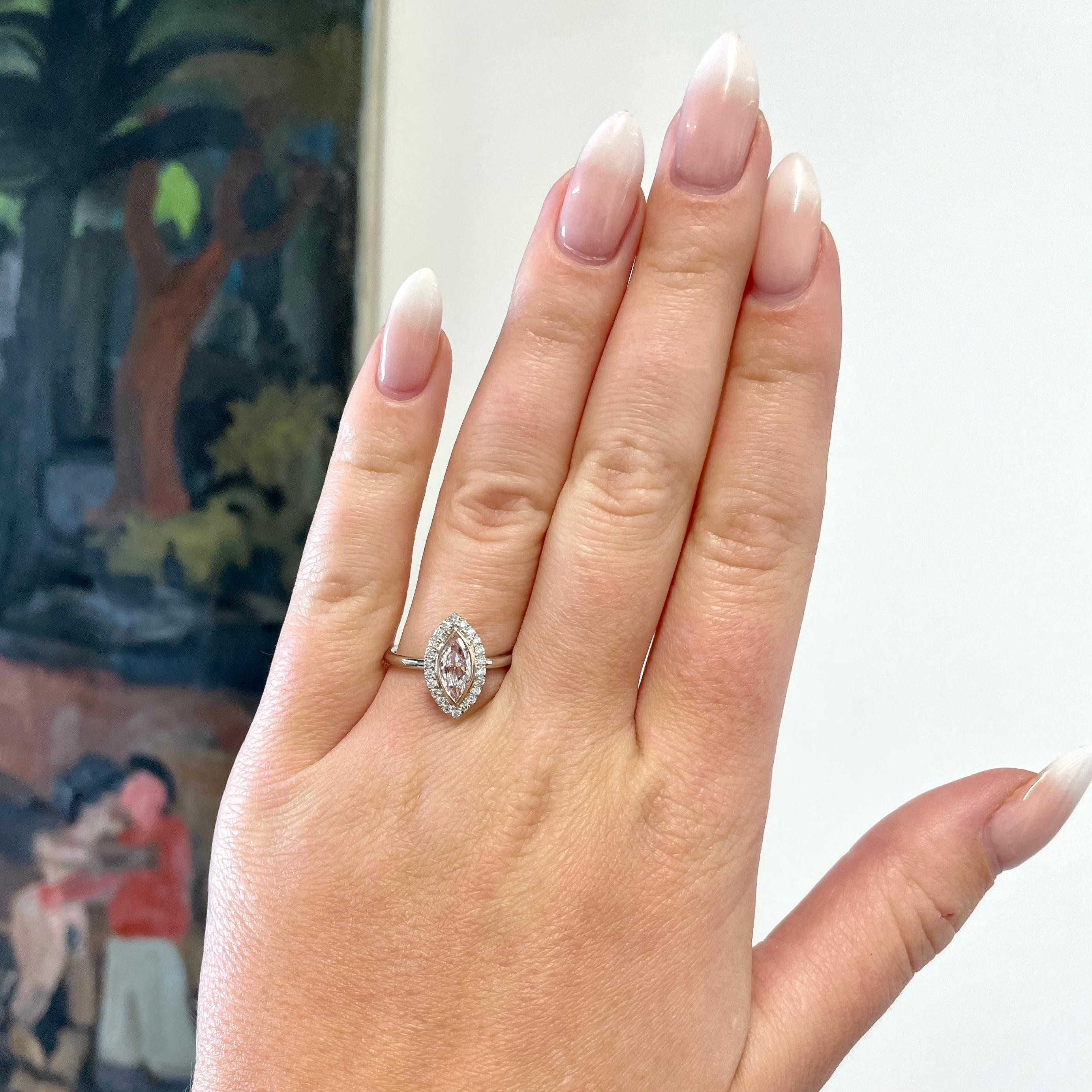 If you are looking for an engagement ring full of character, consider this striking Light Pink Marquise Cut Diamond Platinum Halo Solitaire Engagement Ring. Pink, the  color of true love; you will not go unnoticed wearing this stunner. 

The center