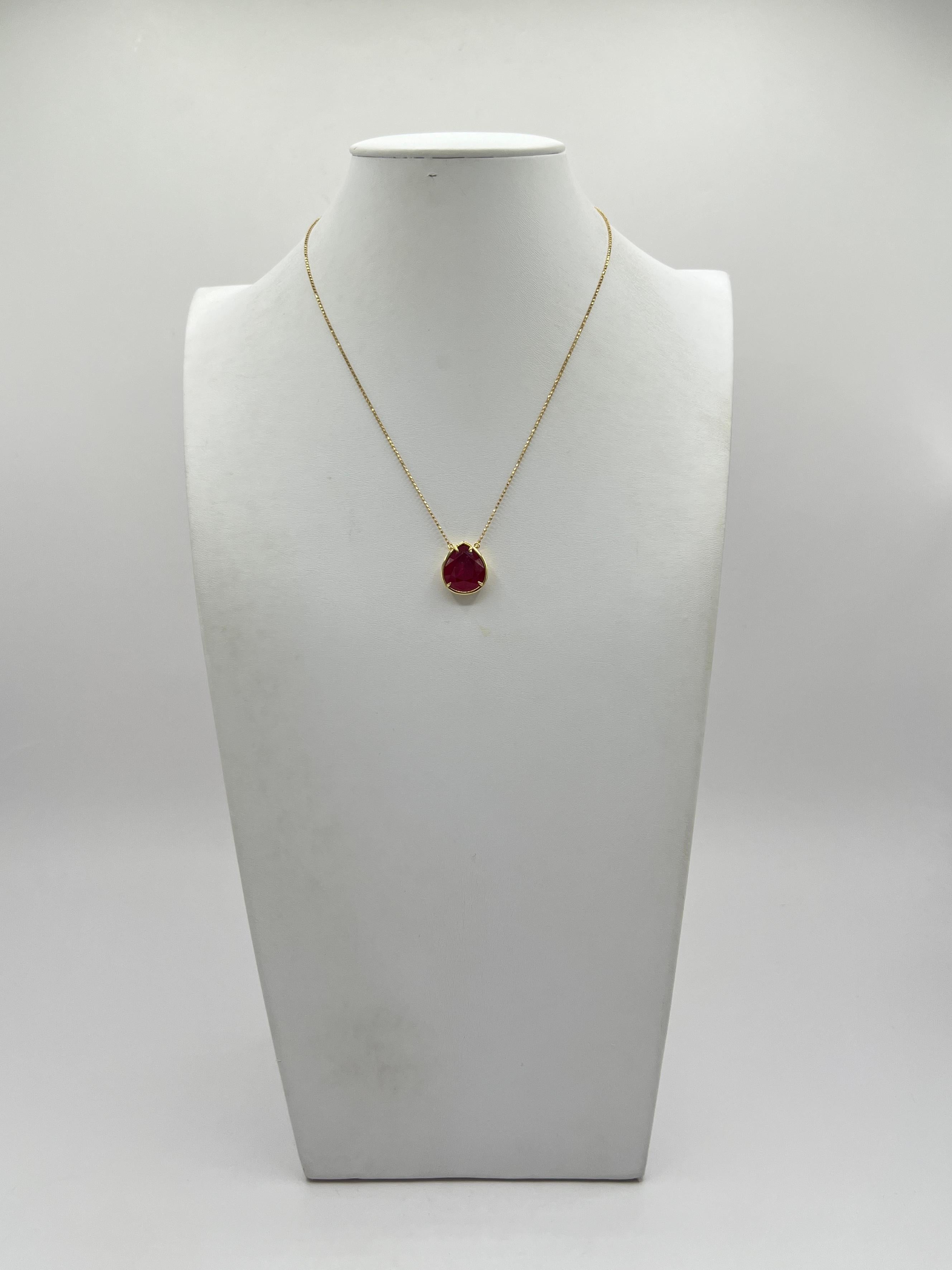 Beautiful bright red Mozambique ruby pear shape weighing 8.08 ct.  Handmade in 18k yellow gold.  Length is 16