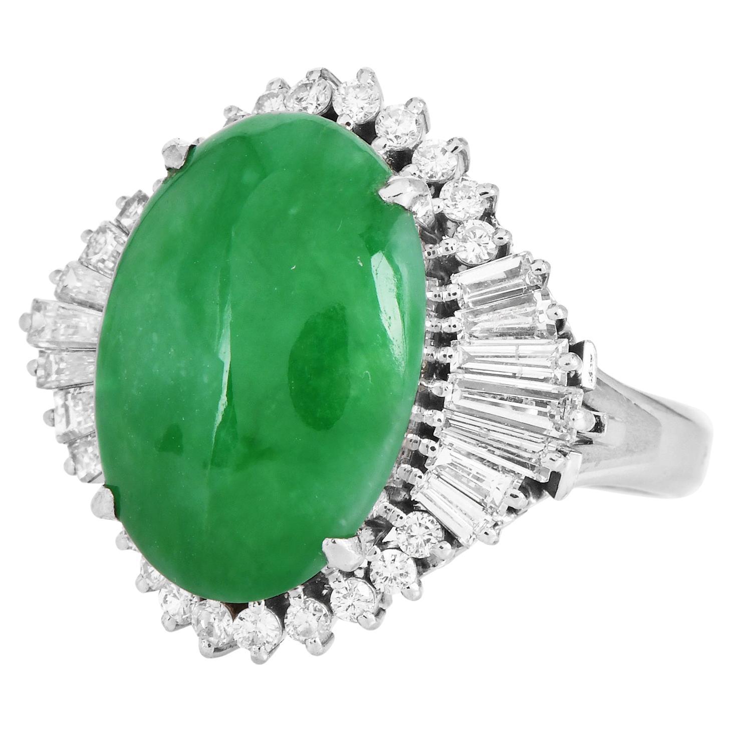 A halo of diamonds surrounds by A Natural Apple Green Jade. 

This jade cocktail ring is  crafted in solid Platinum,  featuring in the center a Cabochon Oval Cut GIA Green Jade of approx. 9.58 carats, natural color without any treatments.

The