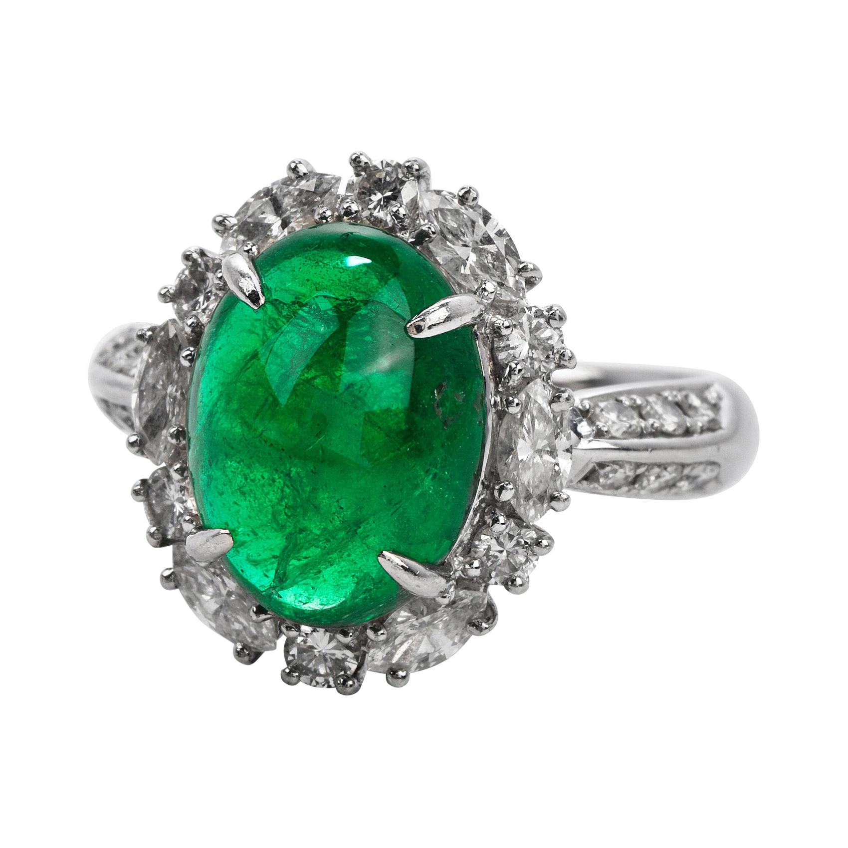 This exquisite GIA Genuine Emerald & Diamond Cocktail Ring is expertly crafted in solid platinum with a total weight of 9.54 grams.

The emerald with a weight of approx. 5.17 carats are surrounded by (6) round cut and (6) marquise cut genuine
