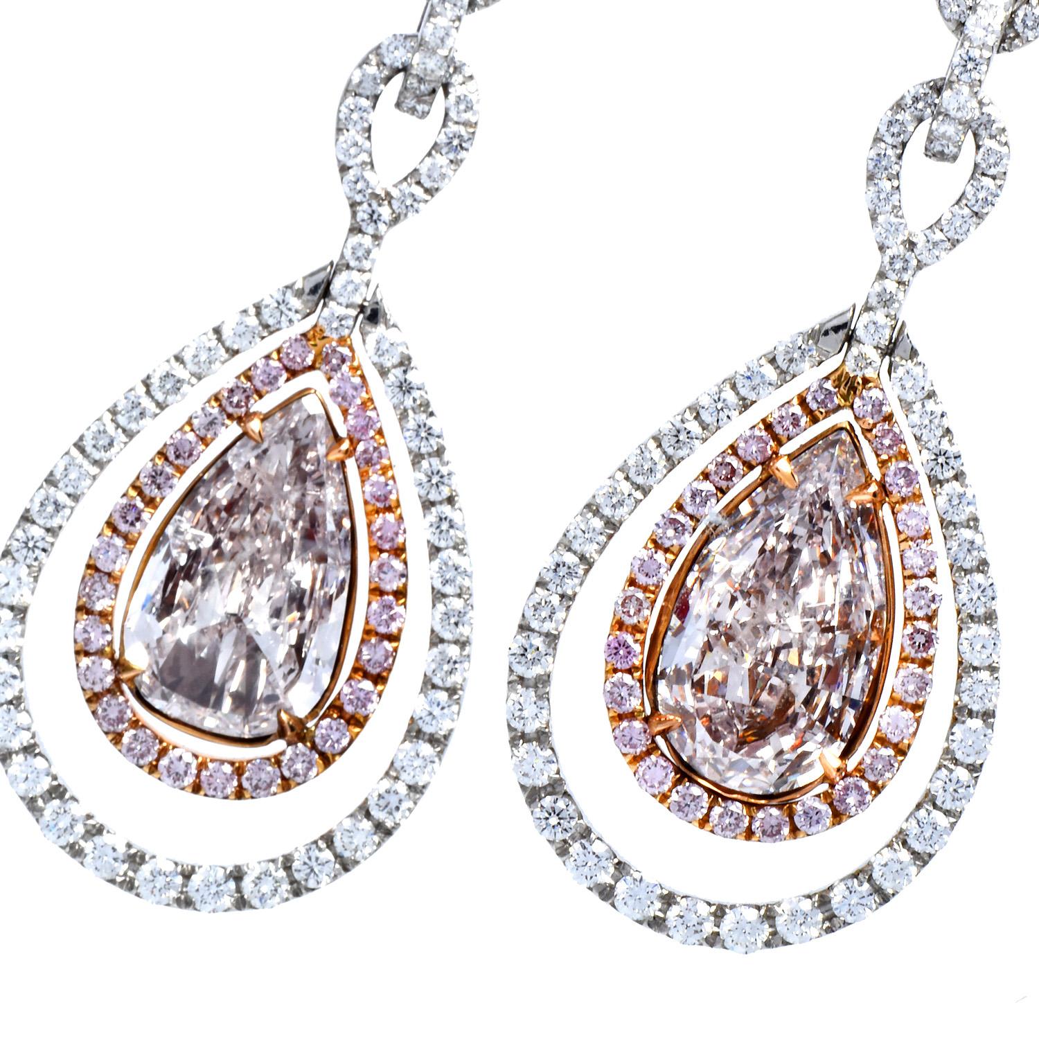 These shimmering GIA Natural Fancy Light Pink Diamond Platinum Gold Dangle Earrings are crafted in solid 18K yellow gold and Platinum.

They display a pear-shaped dangle drop in the center with two genuine pear-cut Natural Fancy Light pink diamonds