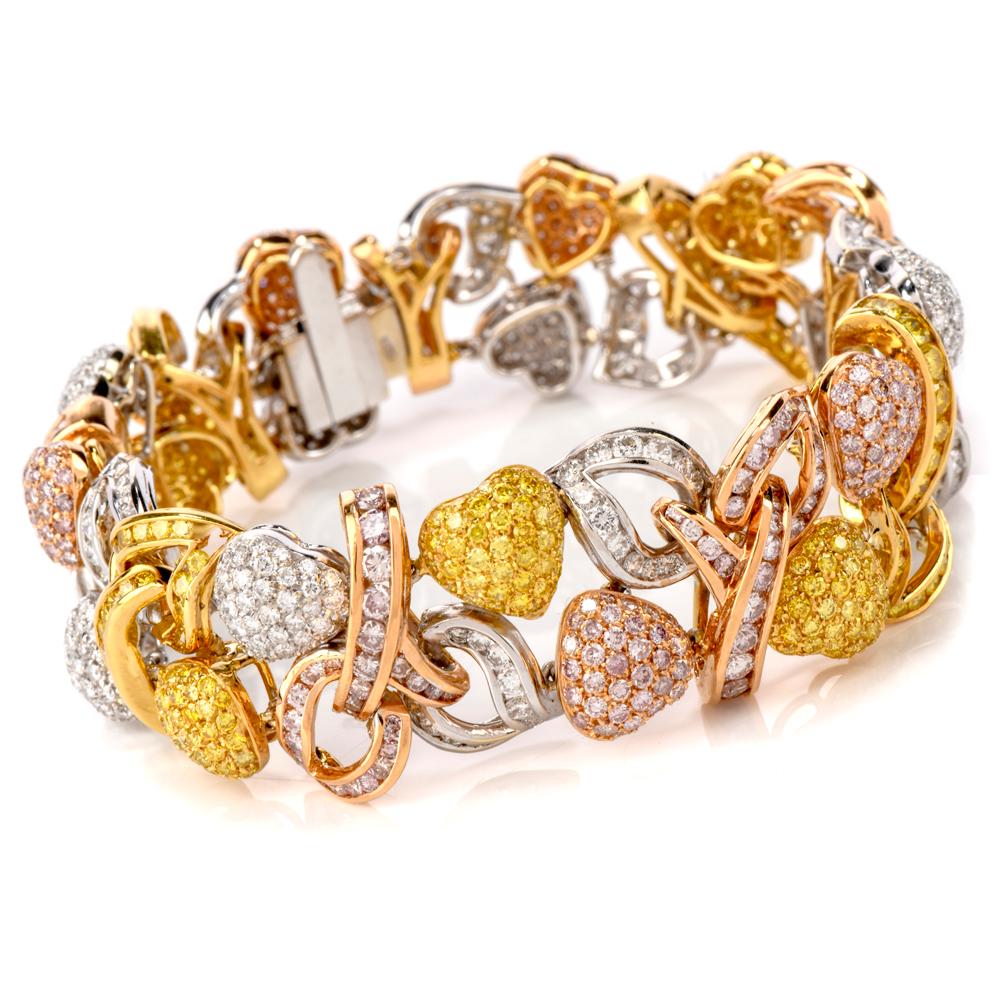 This conspicuous and elaborately designed bracelet is crafted in a combination of solid 18K white, yellow and rose gold.  Depicting romantically inspired heart motif profiles, this exquisite bracelet is adorned with 335 genuine round-faceted
