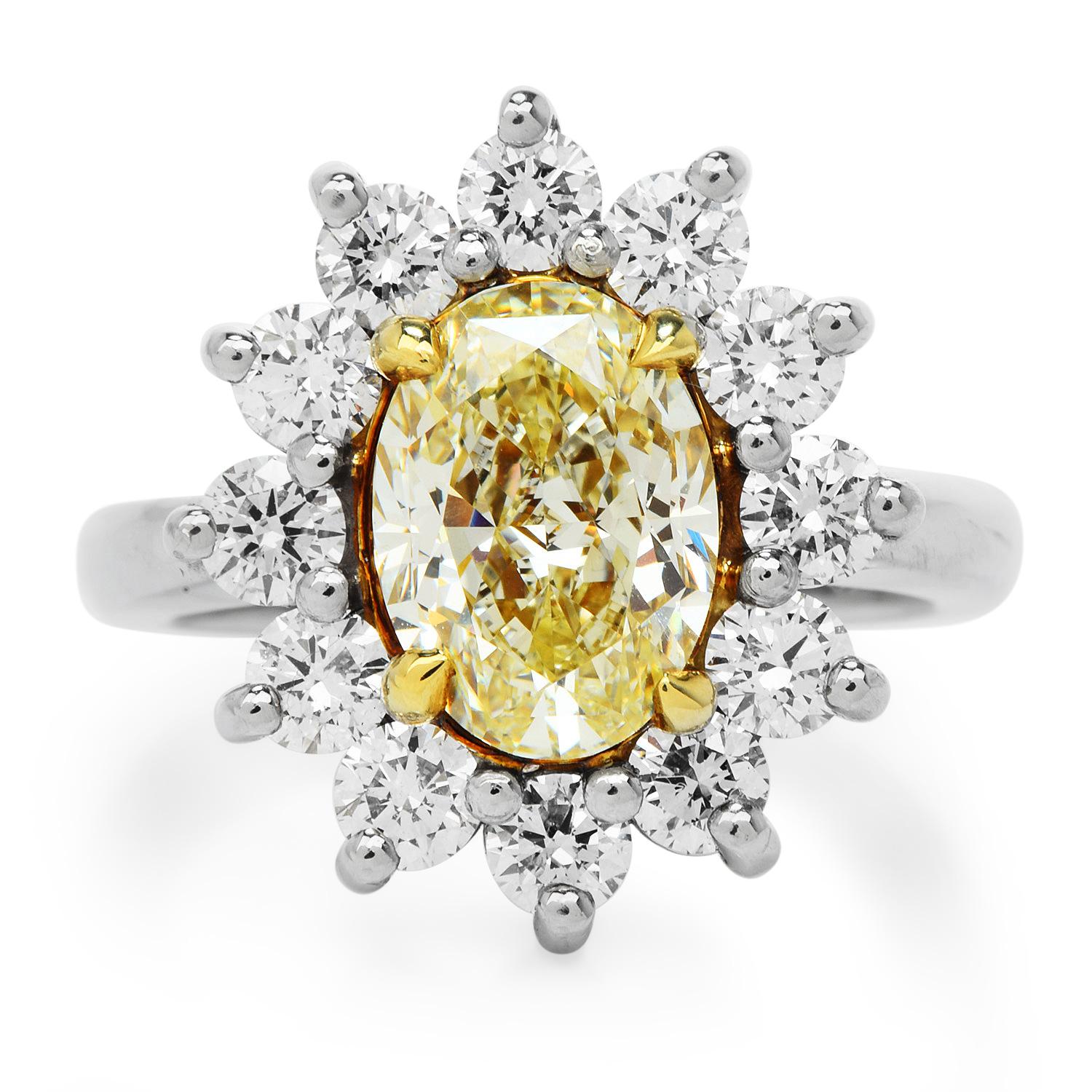 Feel the sunshine every day and every night on your finger, 

This alluring ring was crafted in Luxurious Platinum and accented by 18K yellow gold prongs.

Prominently features in the center a GIA-certified Natural Fancy Light Yellow Diamond, Oval