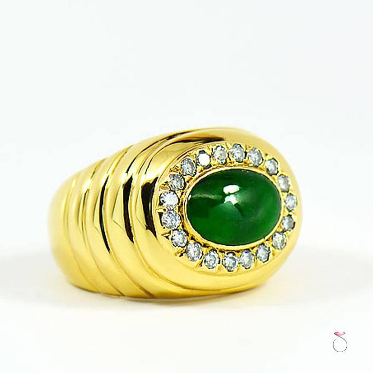 Men's natural green Jadeite Jade in 18k yellow gold with diamond halo. The beautiful High polished green oval cabochon Jadeite jade has a beautiful color, that contrasts gracefully with the rich 18k yellow gold with gorgeous ripple design and the