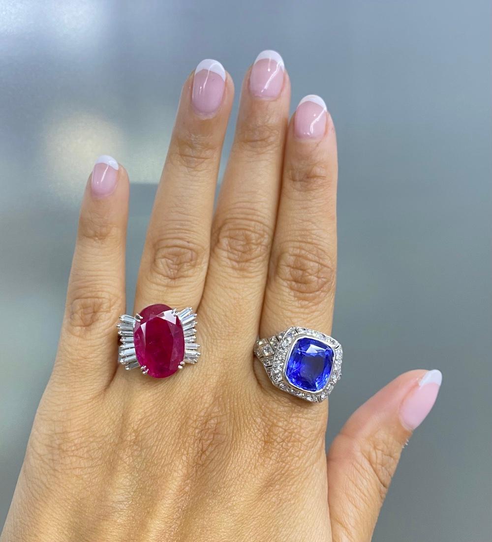 This chic ruby and diamond cocktail ring is crafted in solid platinum, weighing 9.2 grams and 17mm x 9mm high. Showcasing a prominent GIA lab reported oval shaped, prong-set red ruby with no indications of heating, weighing approximately, 9.10