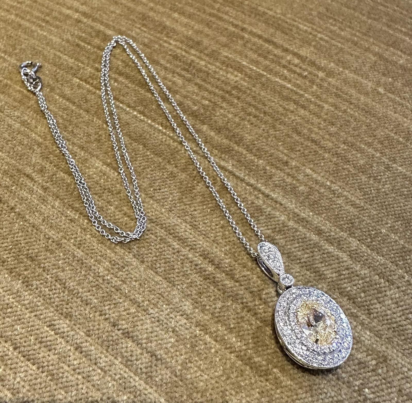 GIA Natural Yellow 1.50 carat Oval Diamond Pendant Necklace in White Gold

Natural Yellow Diamond Pendant Necklace features a GIA certified 1.50 carat Center Oval Diamond with Natural Yellow Color with a two-row Halo of Round White Diamonds and a