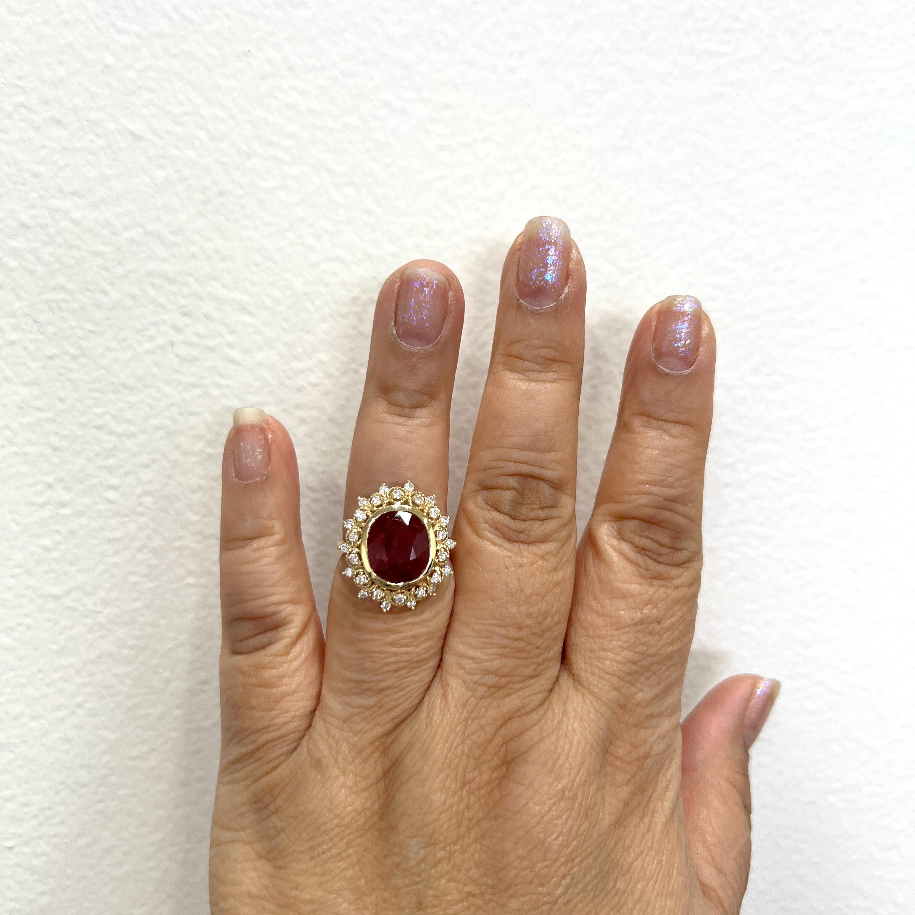 Beautiful 5.20 ct. Unheated Mozambique ruby oval with good quality white diamond rounds.  Handmade in 18k yellow.  Ring size 7.  Comes with GIA certificate.