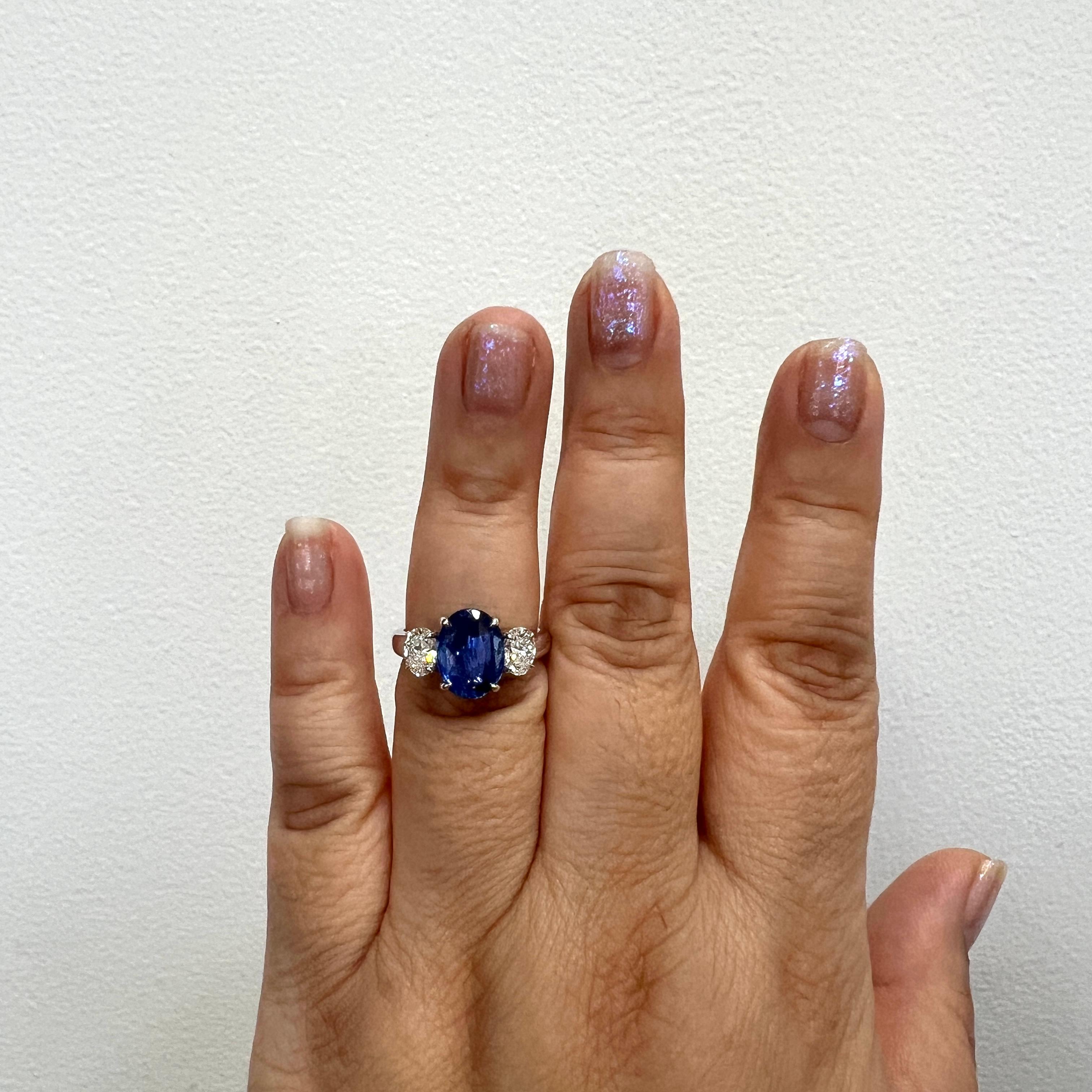 Gorgeous 4.07 ct. unheated blue sapphire oval with 1.00 ct. H VS2 white diamond ovals.  Handmade in 18k white gold.  Ring size 7.  Comes with GIA certificates for all three stones.