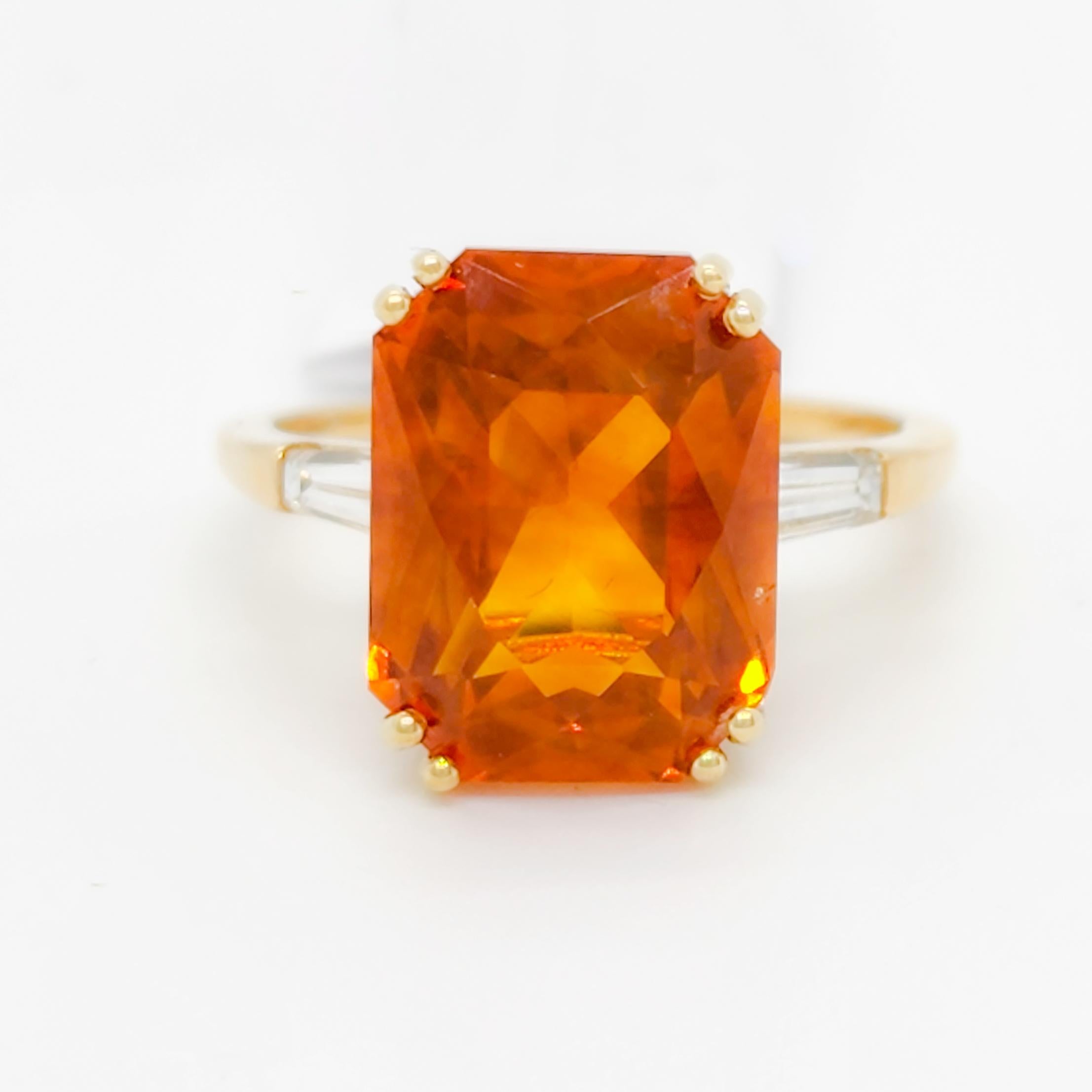 Gorgeous bright 13.04 ct. orange sapphire octagon with 0.20 ct. good quality white diamond baguettes.  Handmade in 18k yellow gold.  Ring size 8.75.  GIA certificate included.