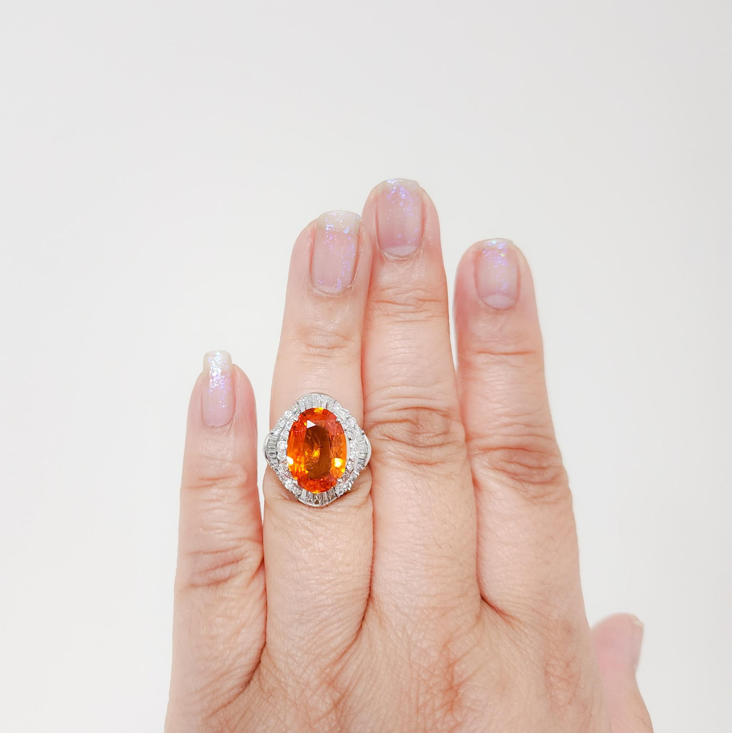 Absolutely stunning 6.17 ct. bright orange sapphire oval with 1.15 ct. good quality white diamond rounds and baguettes.  Handmade in platinum.  Ring size 6.5.
GIA certificate is included.