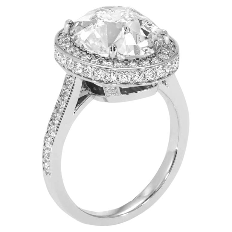 This breathtaking ring features a GIA Certified 5.03 Carat Oval Cut Diamond set in 18K white gold.
The pavé set diamonds along the band add a continuous shimmer, complementing the central stone. 

With a top-tier F color grade, the diamond is nearly