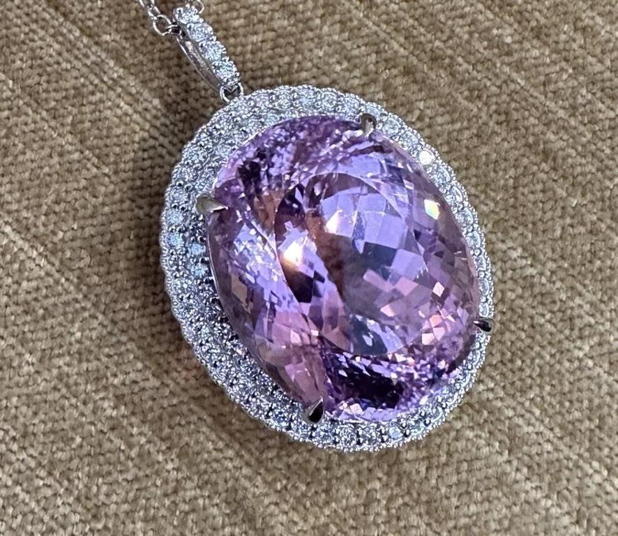 GIA Certified 60.35 carat Oval Kunzite with Diamonds Pendant Necklace in Platinum 

Kunzite Pendant Necklace features a GIA certified Natural Oval Pink Kunzite weighing 60.35 carats surrounded by Two Rows of Natural Round Brilliant cut Diamonds and