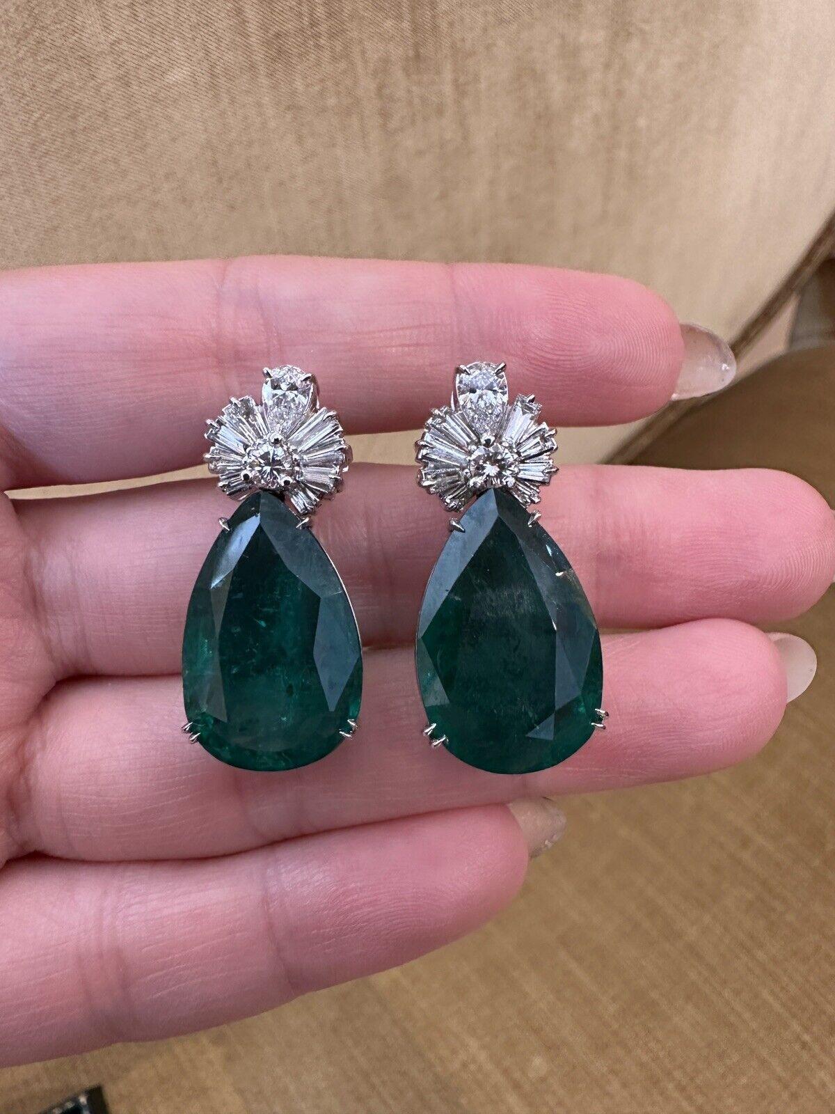 GIA Certified 31.17 carats Pear shape Emeralds and Diamond Earrings in 18k White Gold

Large Emerald and Diamond Drop Earrings feature Natural Pear shaped Emeralds with Round, Baguette, and Pear Diamonds at the top of each Emerald set in Platinum.