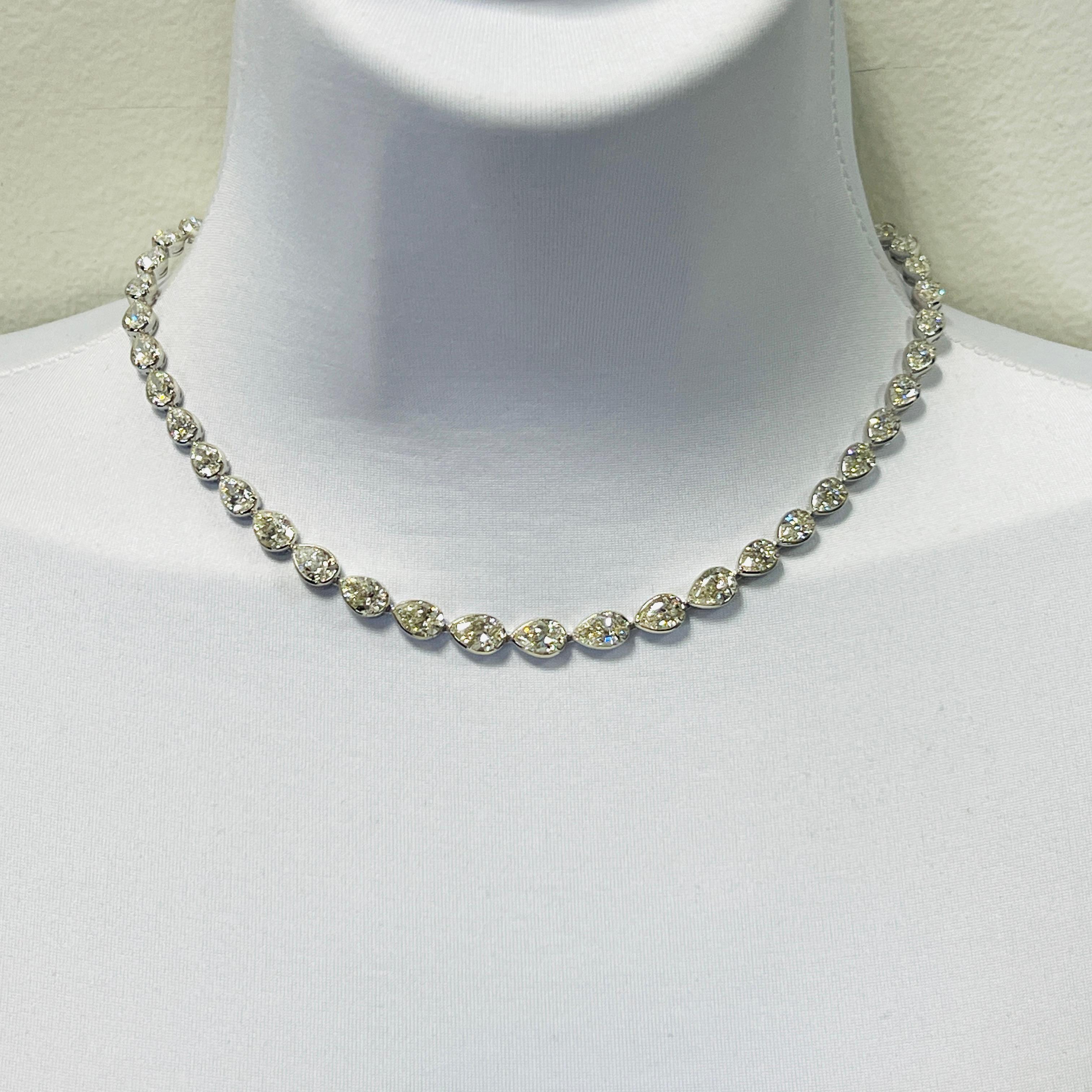 Gorgeous 28.73 ct. IJ VVS-SI white diamond pear shapes.  A total of 47 stones.  The stones are 0.50 ct to 1.00 ct. each.  All stones come with GIA certificates.  Handmade in 18k white gold.  Length is 15