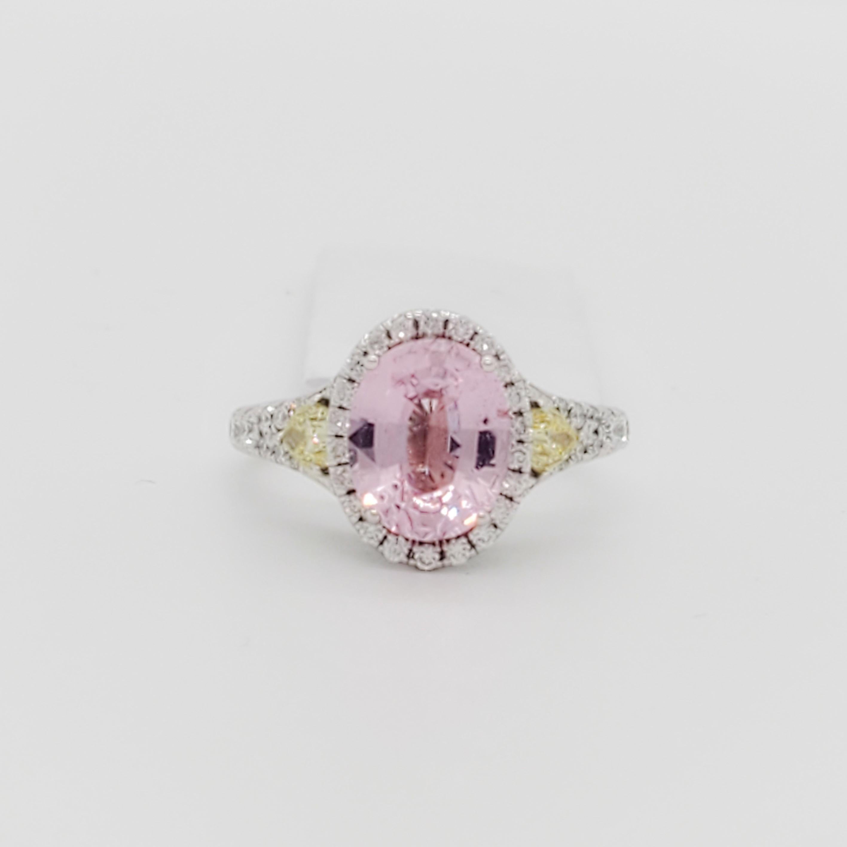 Beautiful 2.17 ct. pink sapphire oval with yellow diamond pear shapes and white diamond rounds.  Handmade in 18k white gold.  Ring size is 5.5.  GIA certificate included.