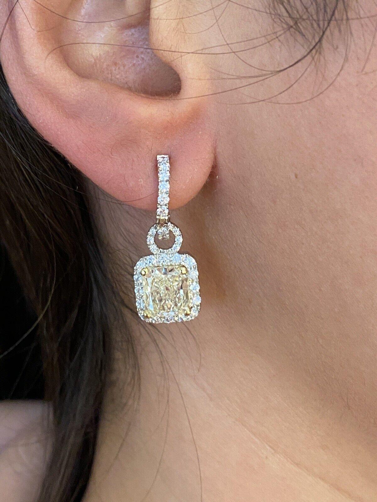 GIA Certified 2.23 carats & 2.38 carats Radiant Cut Diamond Drop Earrings in 18K White & Yellow Gold

Diamond Drop Earrings feature 2 Radiant Cut Diamond centers accented by approximately 1.50 carats of Round Brilliant cut Diamonds set in in 18K