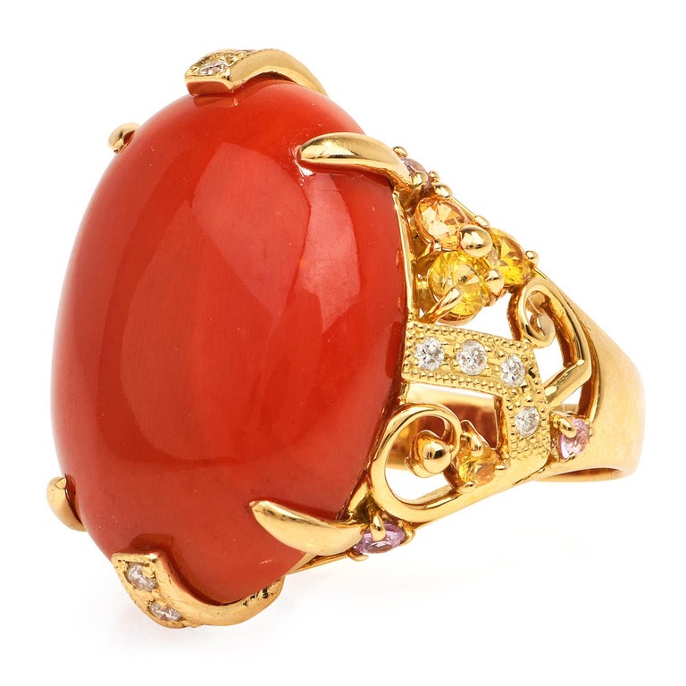 With a Geometric floral multicolor design, this coral cocktail ring has a Retro sophisticated look, 

Crafted in solid 18K yellow gold, the center is adorned by a GIA certified Natural Non-dyed Red Coral, cabochon oval-shaped, bezel set weighing