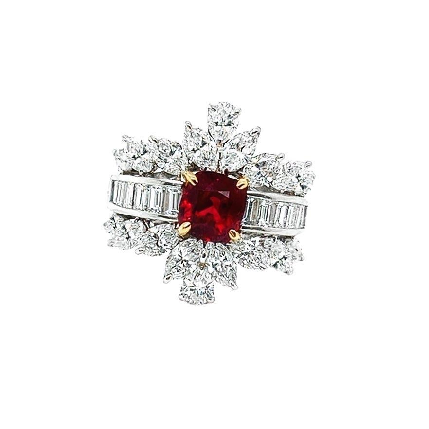 This beautiful spinel and diamond cocktail ring is crafted in yellow gold and platinum. The center stone is a GIA certified cushion cut Red Spinel weighing 1.69 carats. The spinel is surrounded by an array of mixed cut diamonds weighing a total of 