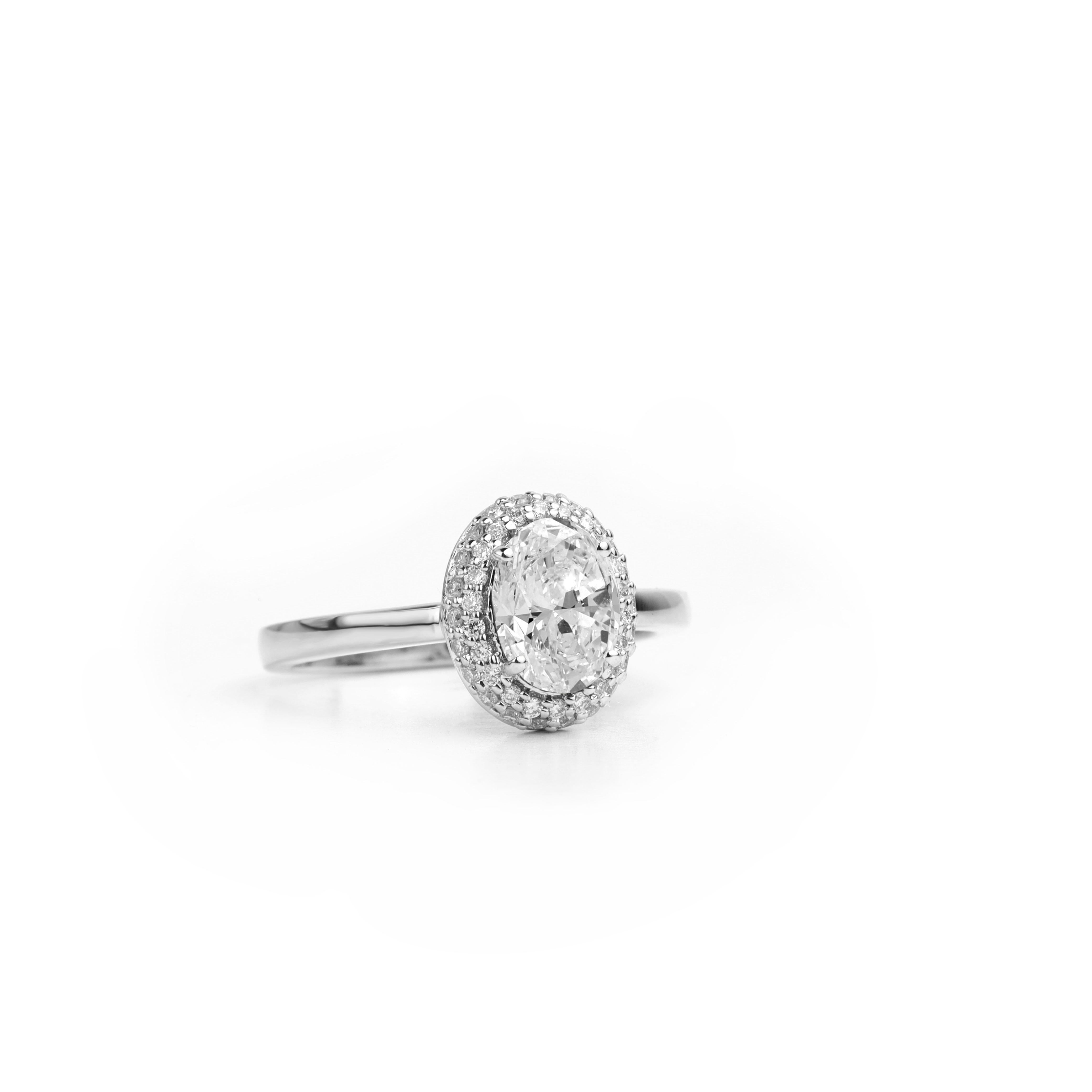Art Deco GIA Report Certified 1 Carat E VS Oval Cut Diamond 18k Halo Engagement Ring For Sale