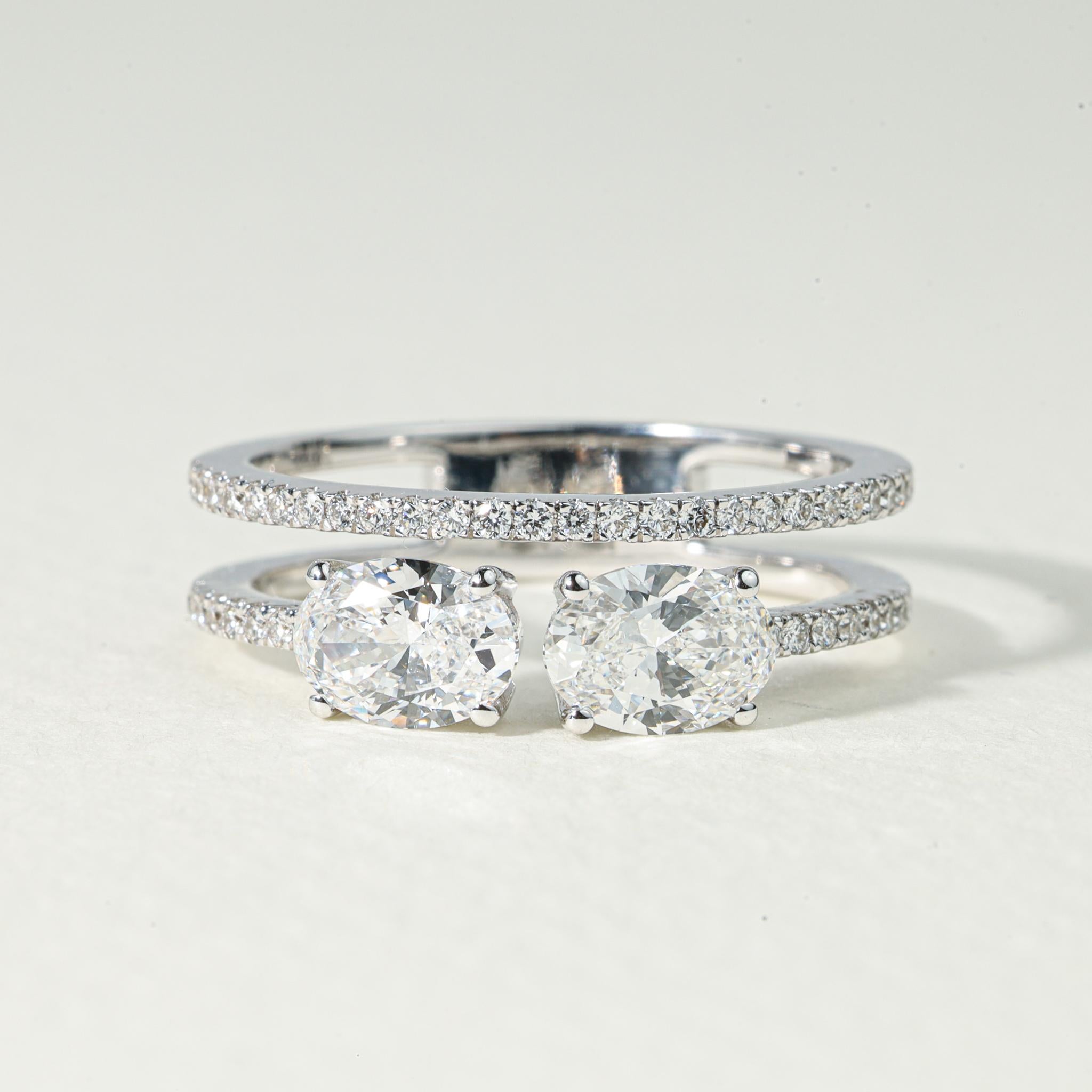 Celebrate the poetic union of two hearts with this captivating Toi et Moi engagement ring, a timeless symbol of duality, devotion, and refined luxury. Crafted by hand in 18K white gold, this romantic masterpiece showcases two natural oval-cut