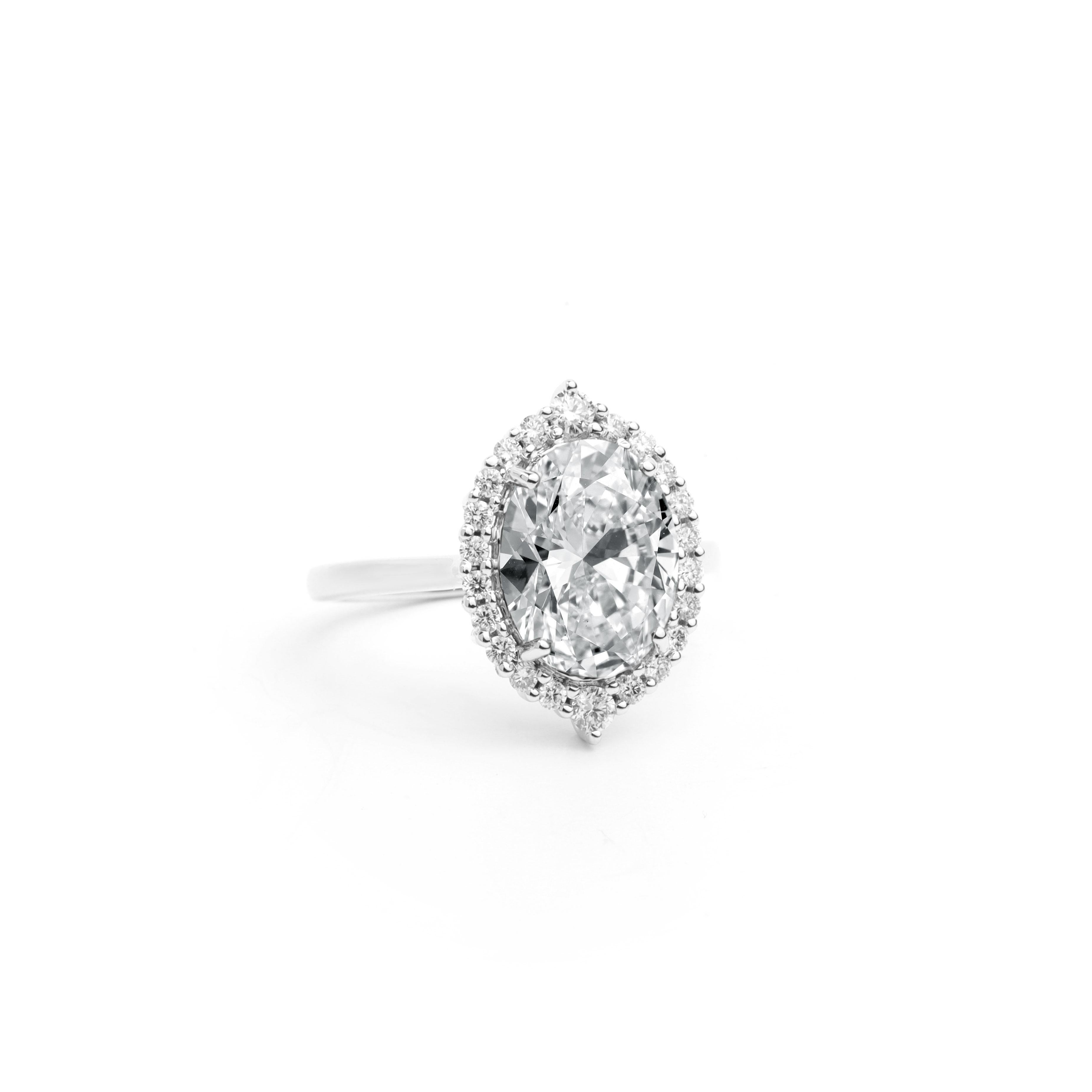 Art Deco GIA Report Certified 3.5 Carat E VS Oval Cut Diamond 18k Halo Engagement Ring For Sale