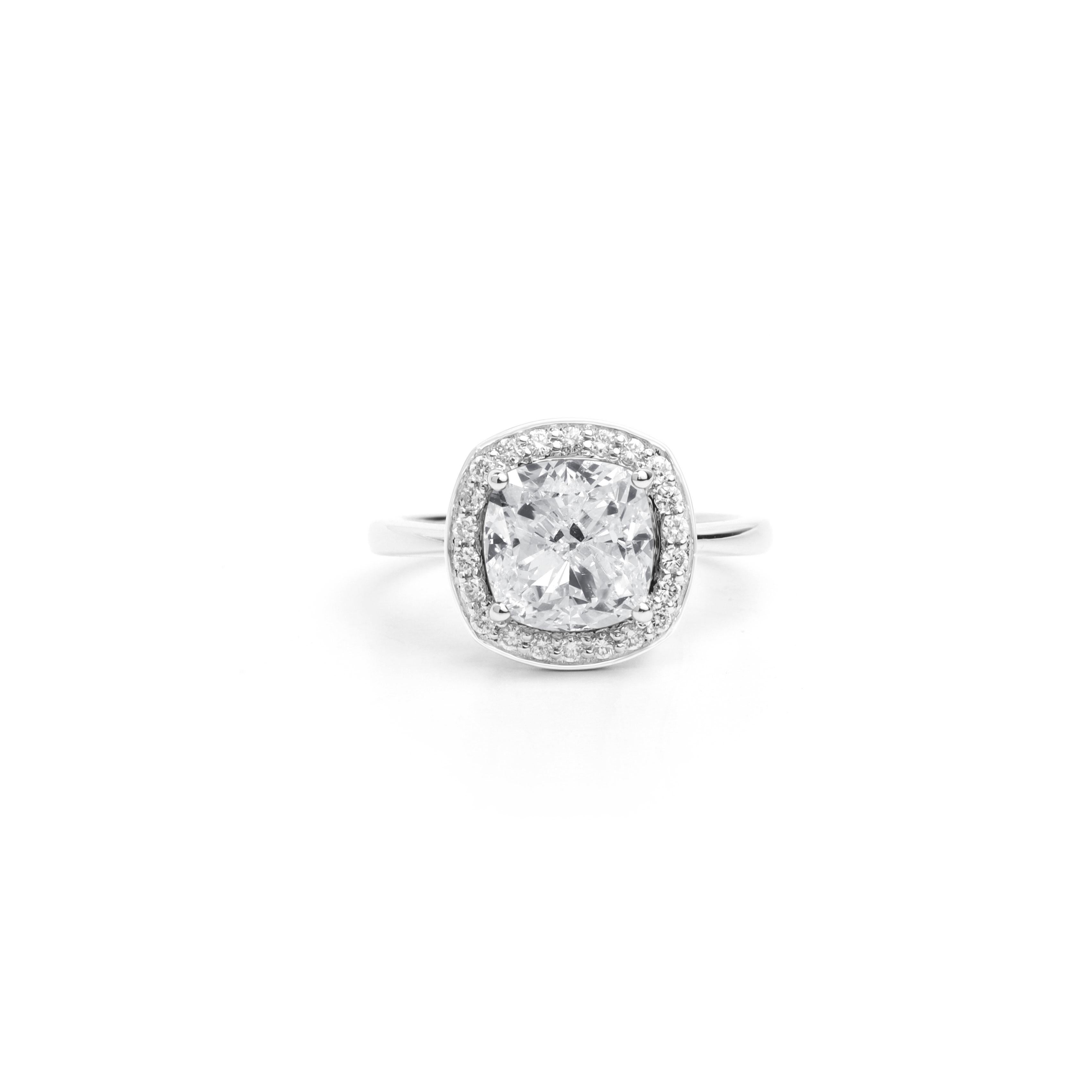 GIA Report Certified 3.5 Carat F VS Cushion Cut Diamond 18k Halo Engagement Ring

Crafted with precision and elegance, the diamond is delicately set in a halo design, accentuated by shimmering round diamonds along the band. The 18k gold setting adds