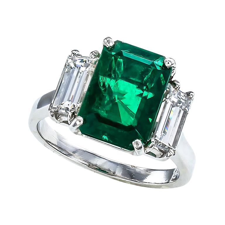 GIA Report Certified 3.98 Carat Emerald Diamond Three Stone Platinum Ring