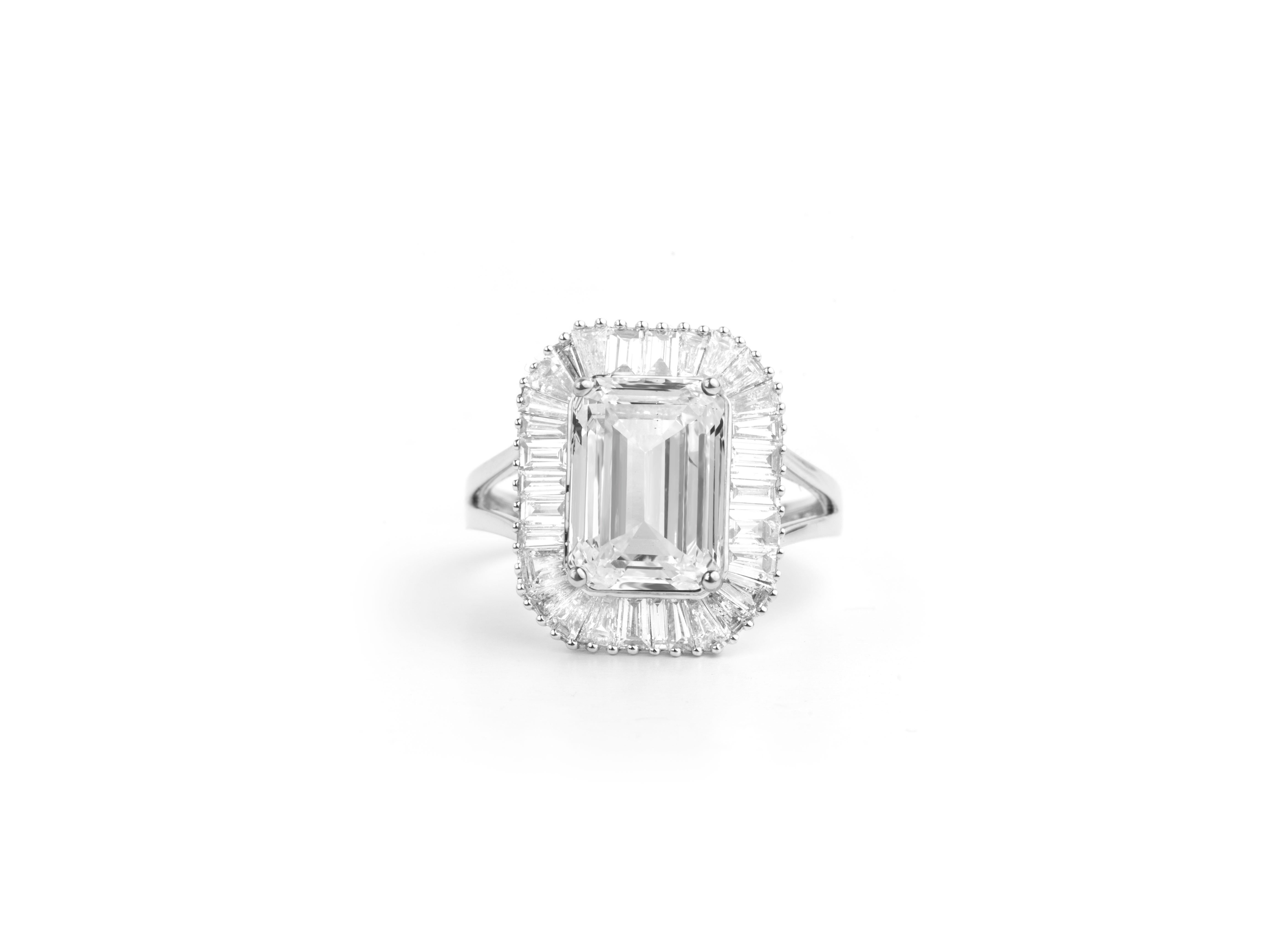 GIA Report Certified 4 Carat H VS Emerald Cut Diamond 18k Halo Engagement Ring

Crafted with precision and elegance, the diamond is delicately set in a halo design, accentuated by shimmering round diamonds along the band. The 18k gold setting adds a