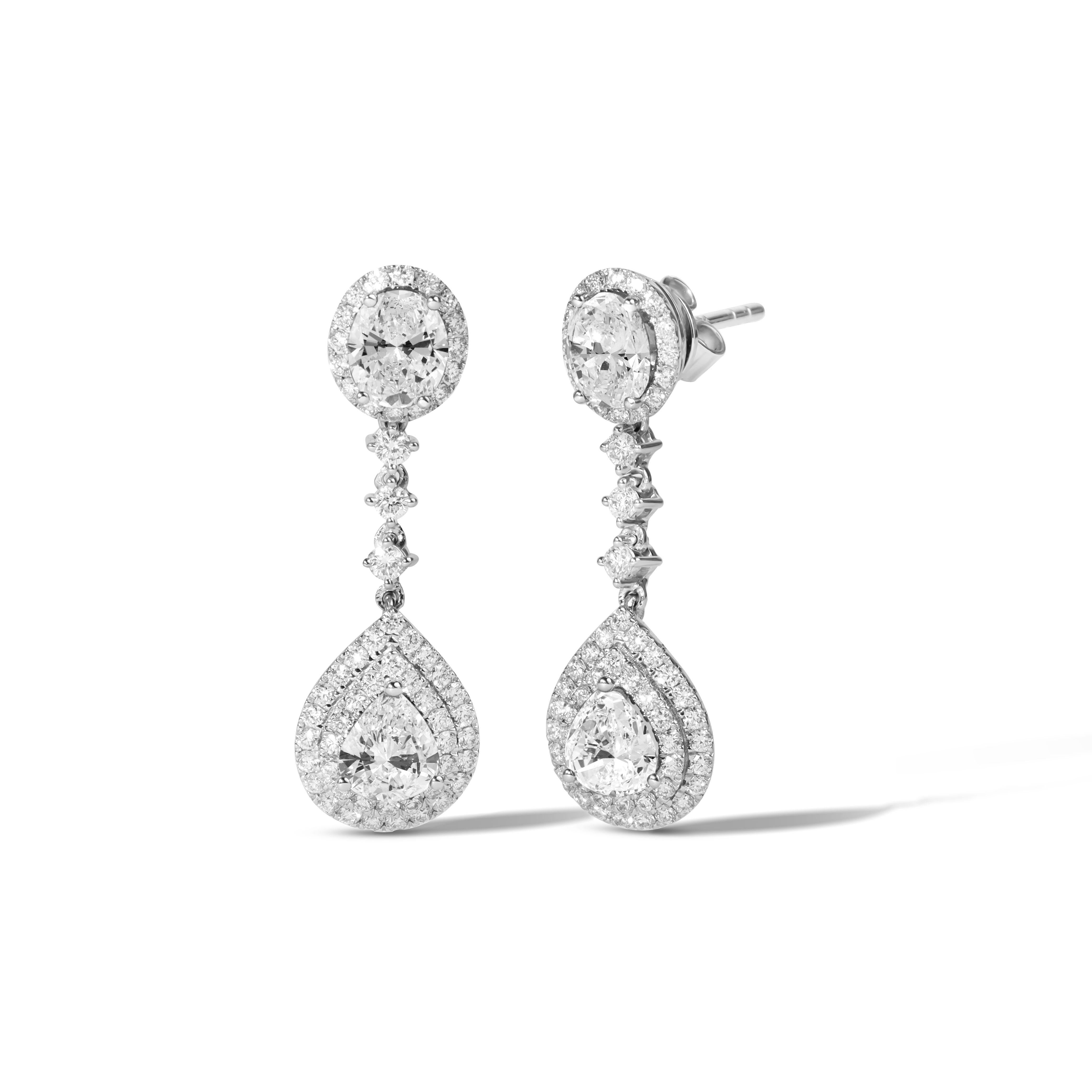 Where Elegance Meets Masterful Brilliance.

These breathtaking double halo dangle earrings are a striking celebration of design symmetry and vintage-inspired luxury. Meticulously handcrafted in 18K white gold, each earring features a radiant pairing