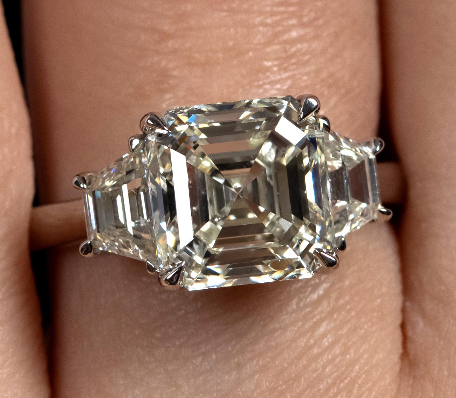 A Breathtaking Estate Handmade Platinum (stamped) Asscher Diamond Three-Stone Engagement ring. The Prong Set Asscher Diamond is 4.03CT with measurements of 8.77x8.60x5.82mm; GIA Certified as M color and SI2 clarity (Appears Warm White and Eye