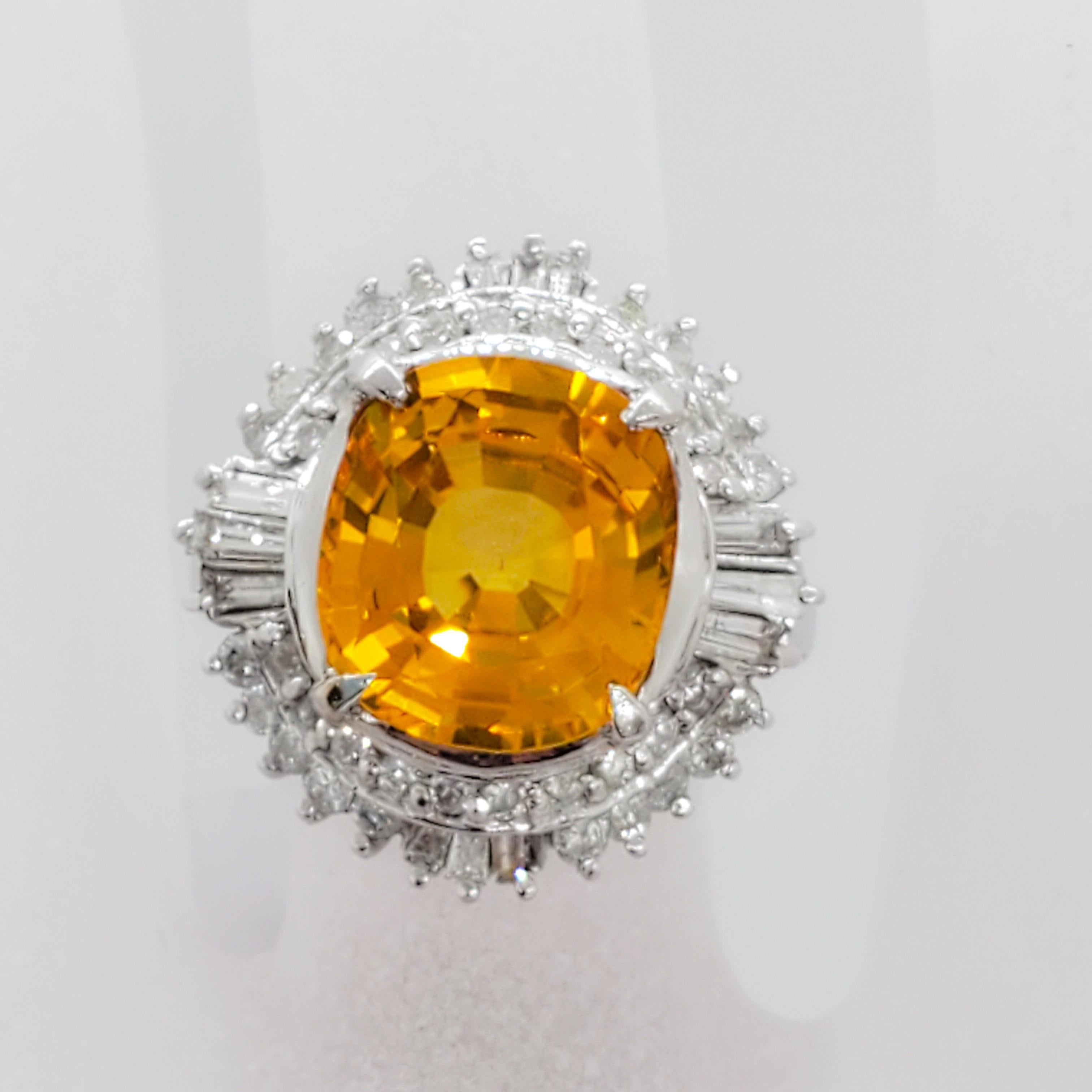 Gorgeous orange yellow Sri Lanka sapphire cushion with a deep orange yellow color weighing 6.36 ct. and 1.00 ct. of good quality white diamond baguettes and rounds. Handmade mounting in platinum. Ring size 6. Estate ring in mint condition. GIA