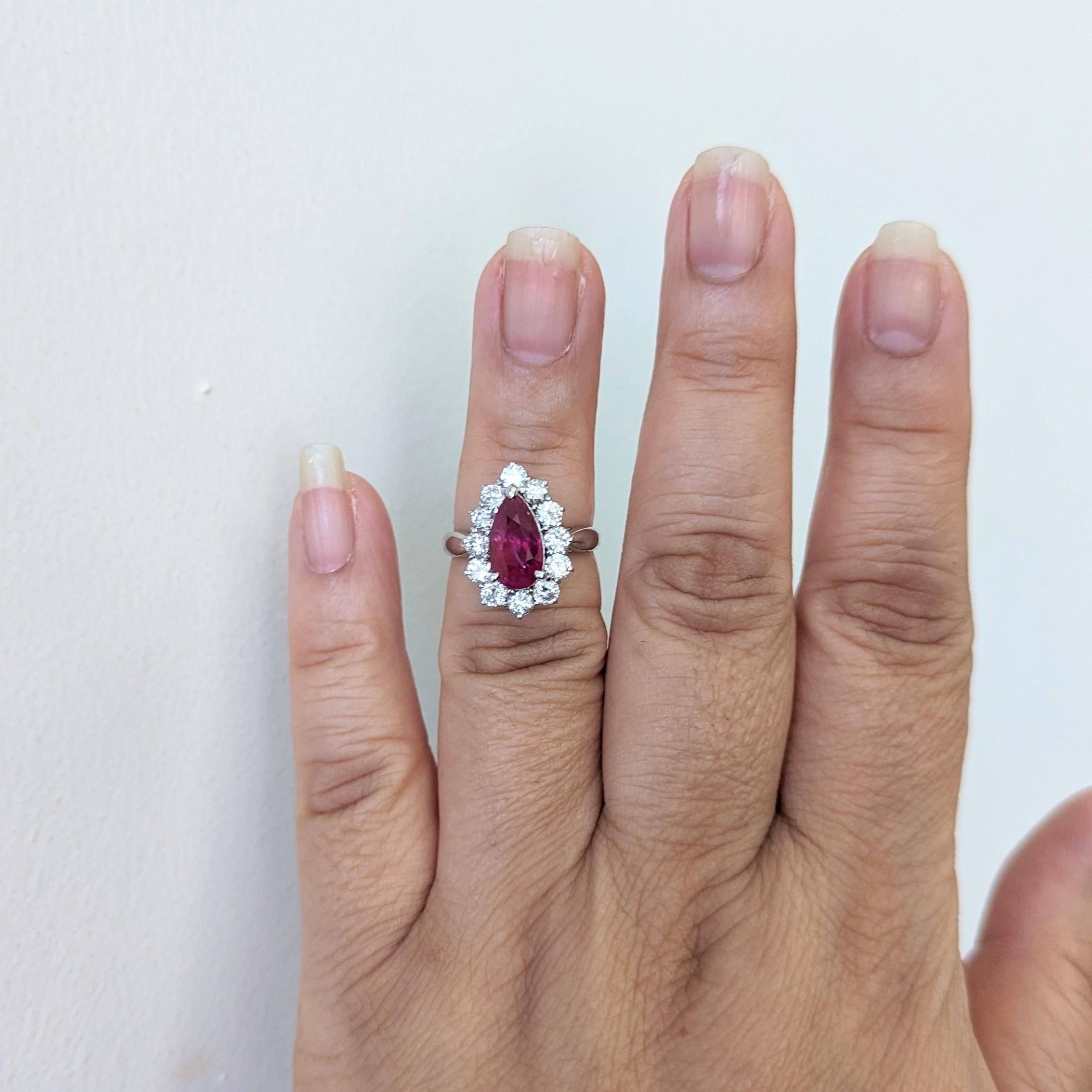 Gorgeous 3.01 ct. unheated Mozambique purplish red ruby pear shape with 1.24 ct. white diamond rounds.  Handmade in platinum.  Ring size 6.25.  GIA certificate included.