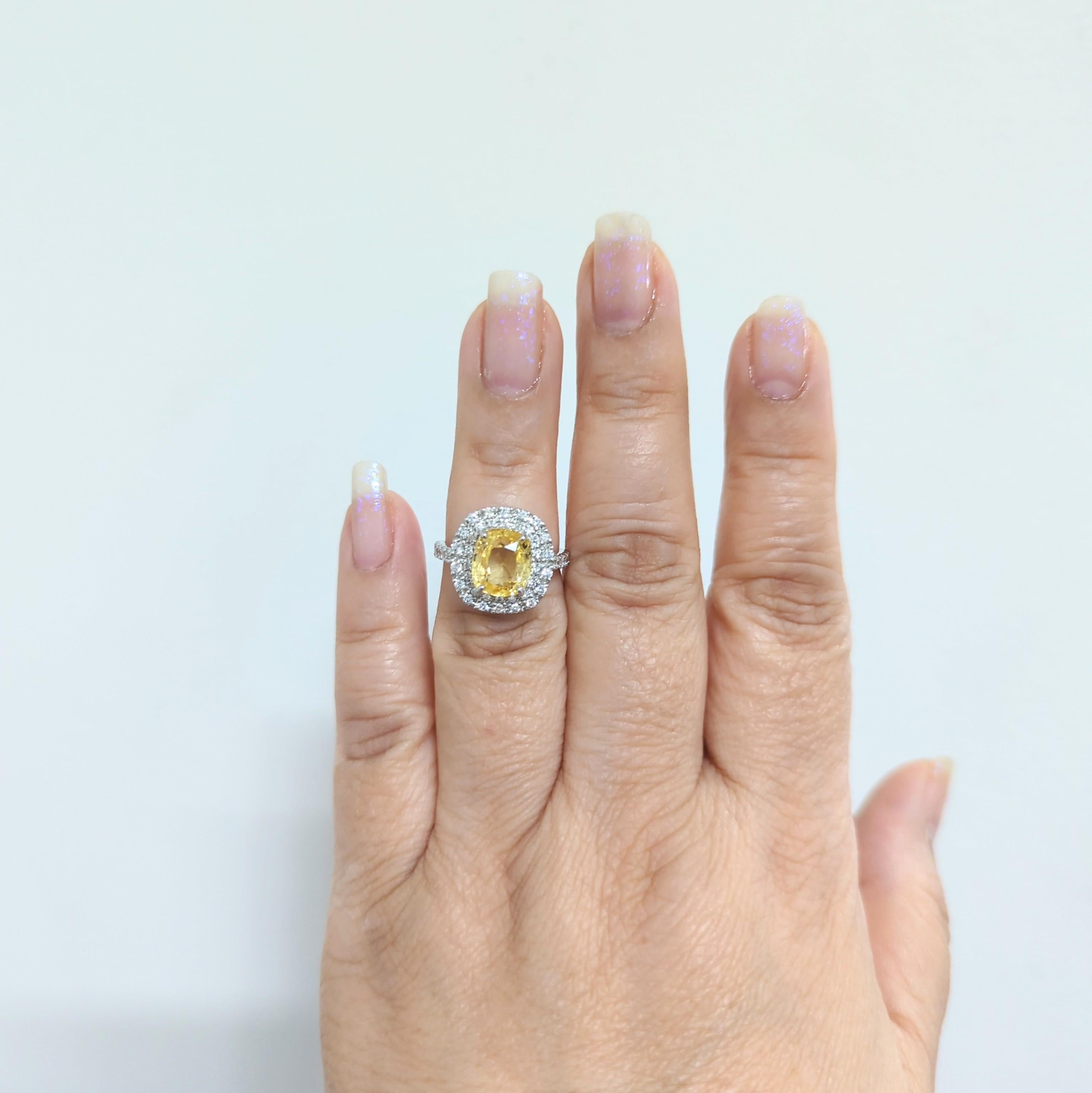 Bright and beautiful 4.25 ct. GIA unheated Sri Lanka orangy yellow sapphire cushion with good quality white diamond rounds.  Handmade in platinum.  Ring size 6+. GIA certificate included.