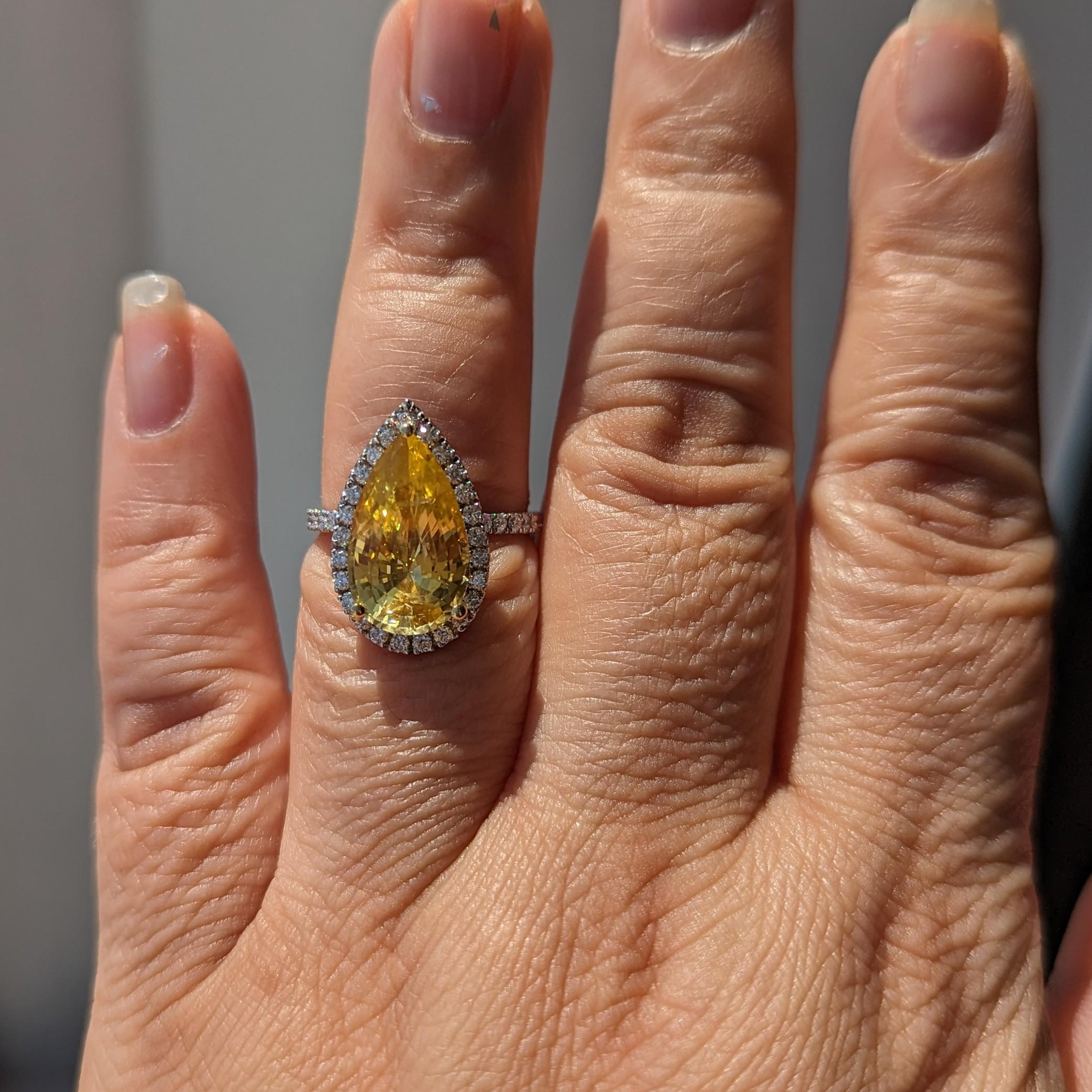 Gorgeous unheated 6.20 ct. orangy yellow pear shape sapphire with 0.72 ct. good quality white diamond rounds.  Handmade in 18k yellow gold and platinum.  Ring size 6.75+.  GIA certificate included.