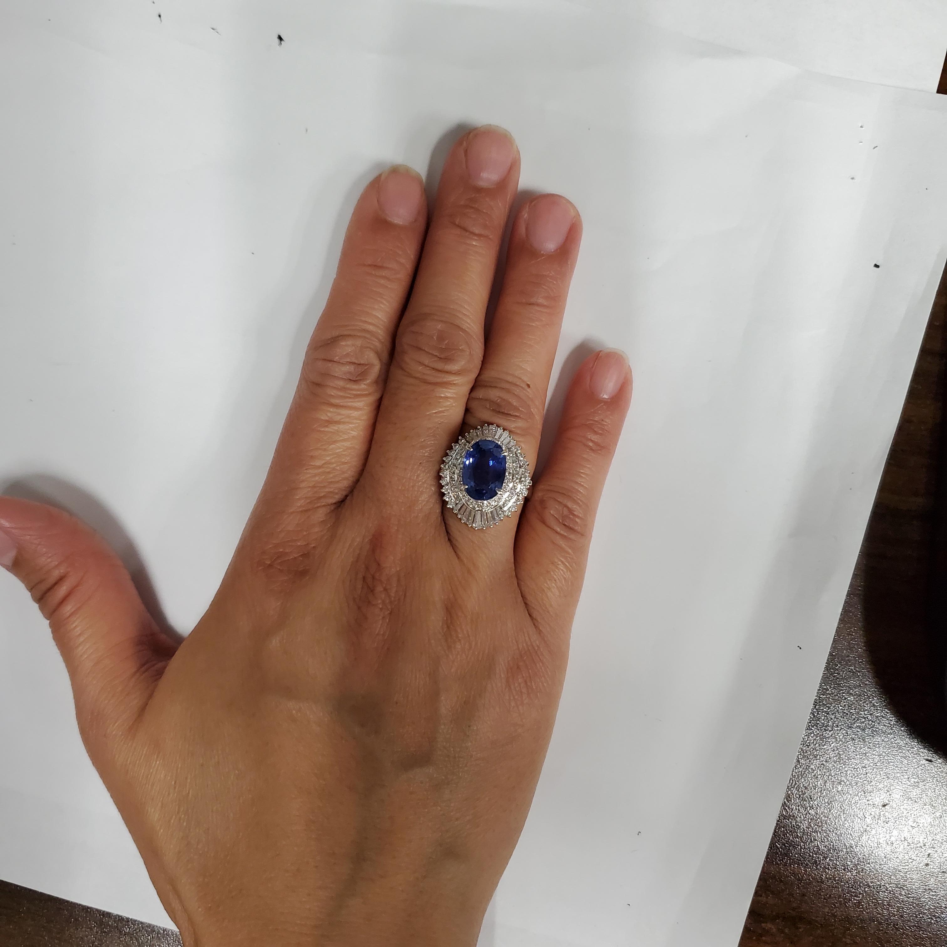 Gorgeous deep blue color unheated Sri Lanka blue sapphire oval weighing 5.18 ct. with 1.62 ct. good quality, white, and bright diamond rounds and baguettes.  Handmade platinum mounting in size 6.25.  Comes with GIA certificate.