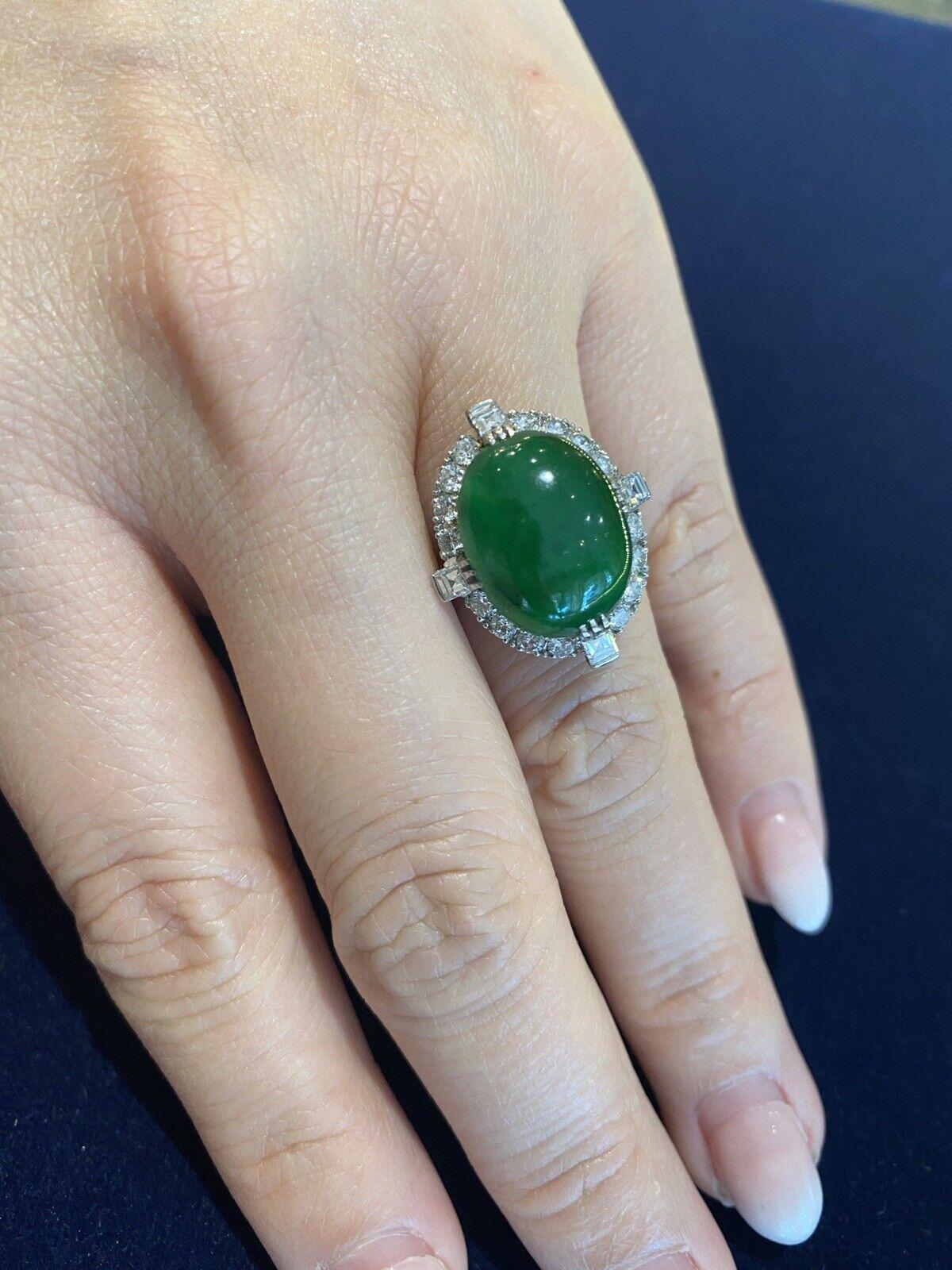 GIA Untreated Jade Oval Cabochon and Diamond Vintage Platinum Ring

Vintage Jade Cabochon Ring features a large Oval Jade Cabochon surrounded by 20 Round and Square Diamonds in a Vintage Platinum Setting.

The Jade is natural and untreated.
Total