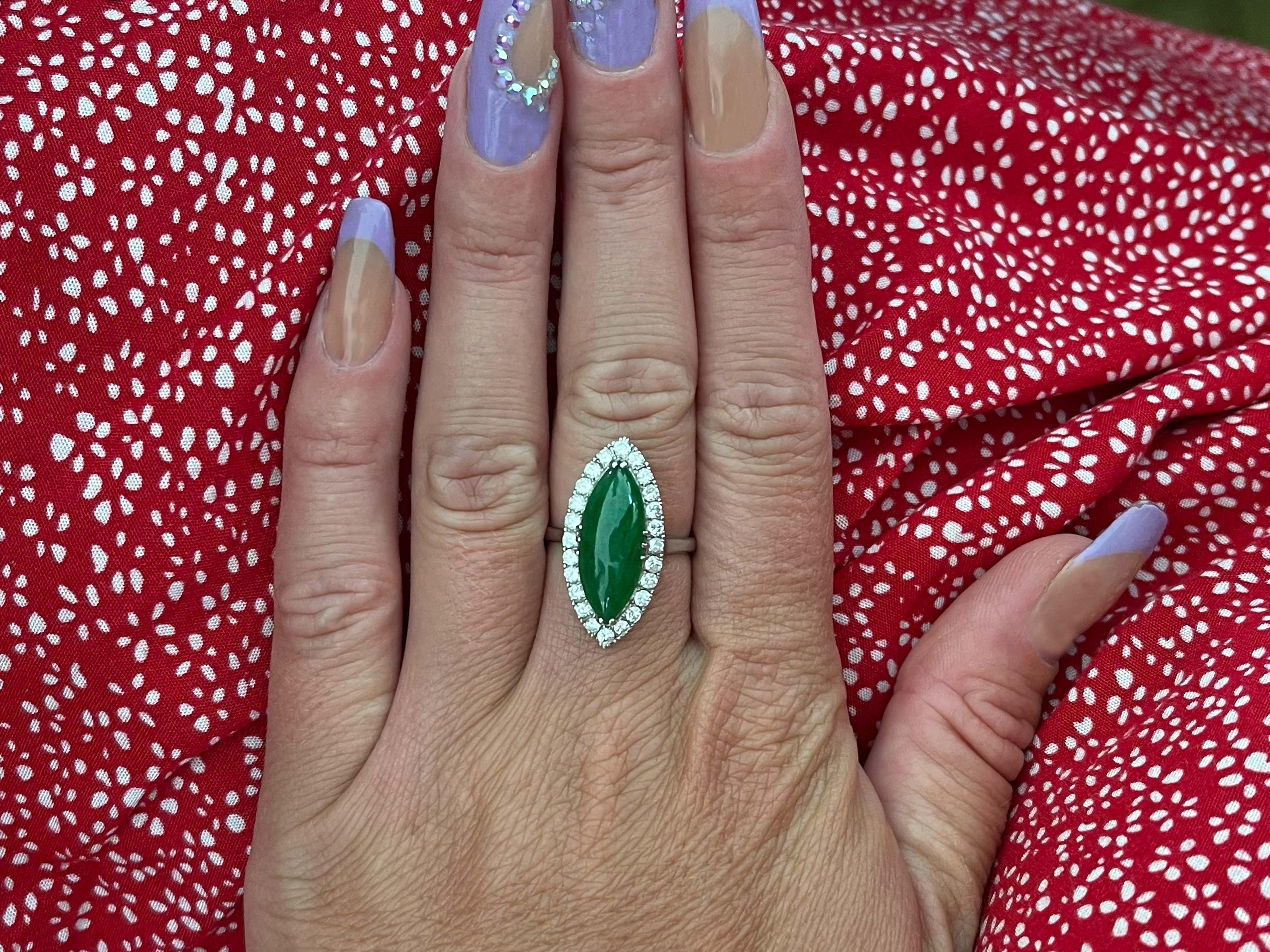 GIA Vintage Marquise Double Cabochon Green Translucent Jadeite Jade and Diamond Ring in Platinum. The ring is set with a gorgeous Marquise shape double cabochon green jadeite jade with a 24 round brilliant diamond halo. The center Jadeite Jade is